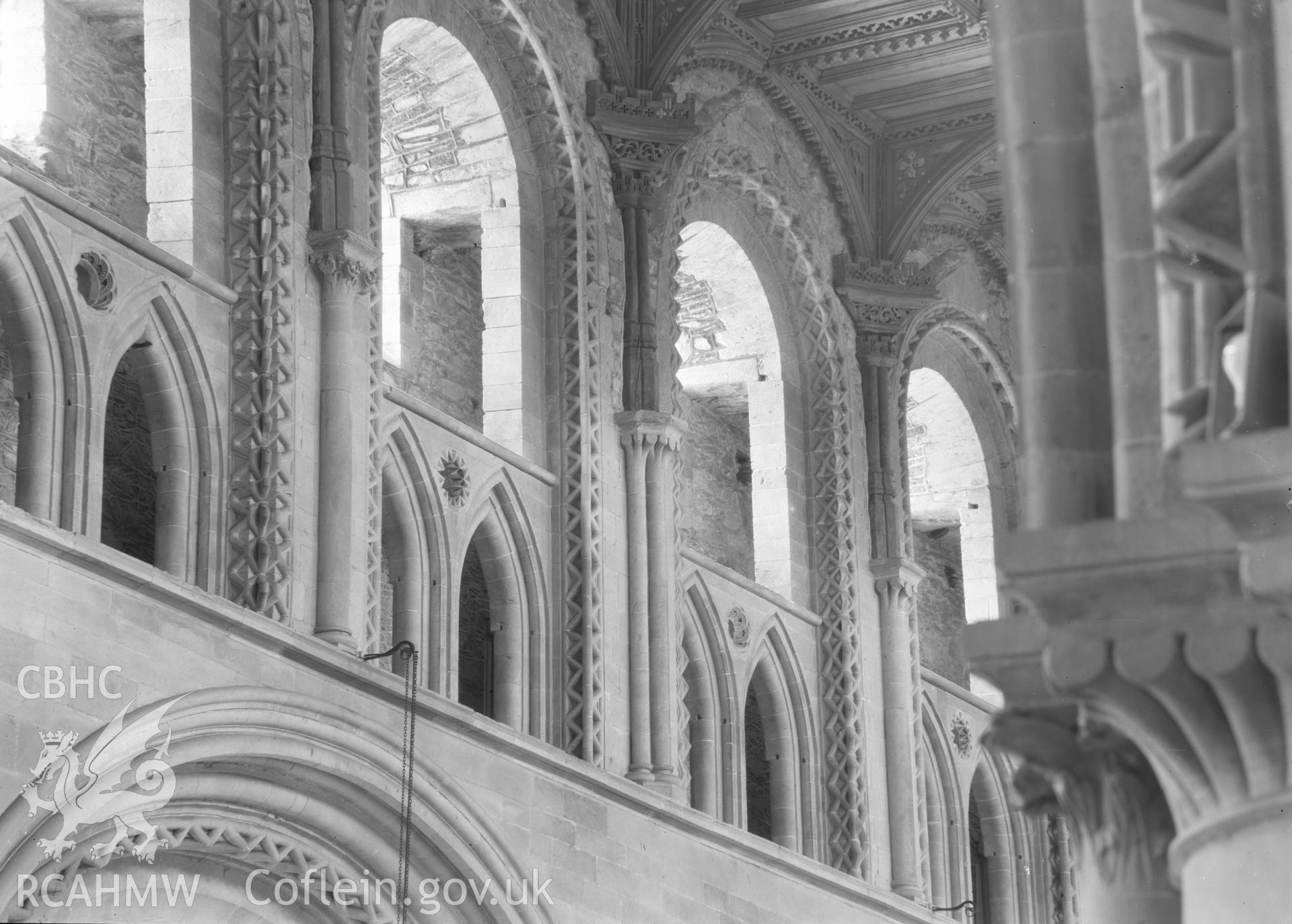 Digital copy of a black and white nitrate negative showing detailed interior view of decorated window arches at St. David's Cathedral, taken by E.W. Lovegrove, July 1936.