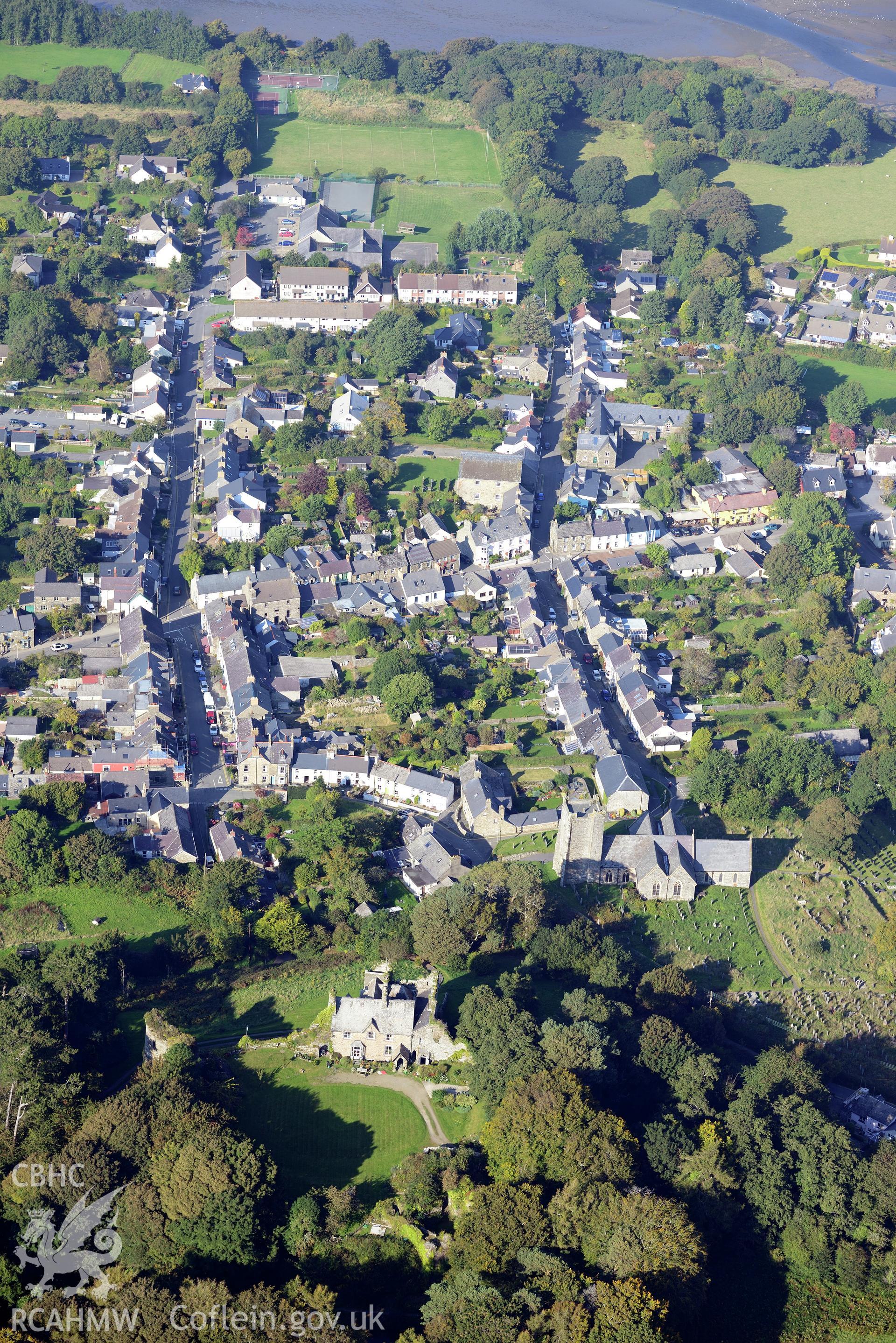 Newport Castle and St. Mary's Church in the town of Newport, Pembrokeshire. Oblique aerial photograph taken during the Royal Commission's programme of archaeological aerial reconnaissance by Toby Driver on 30th September 2015.