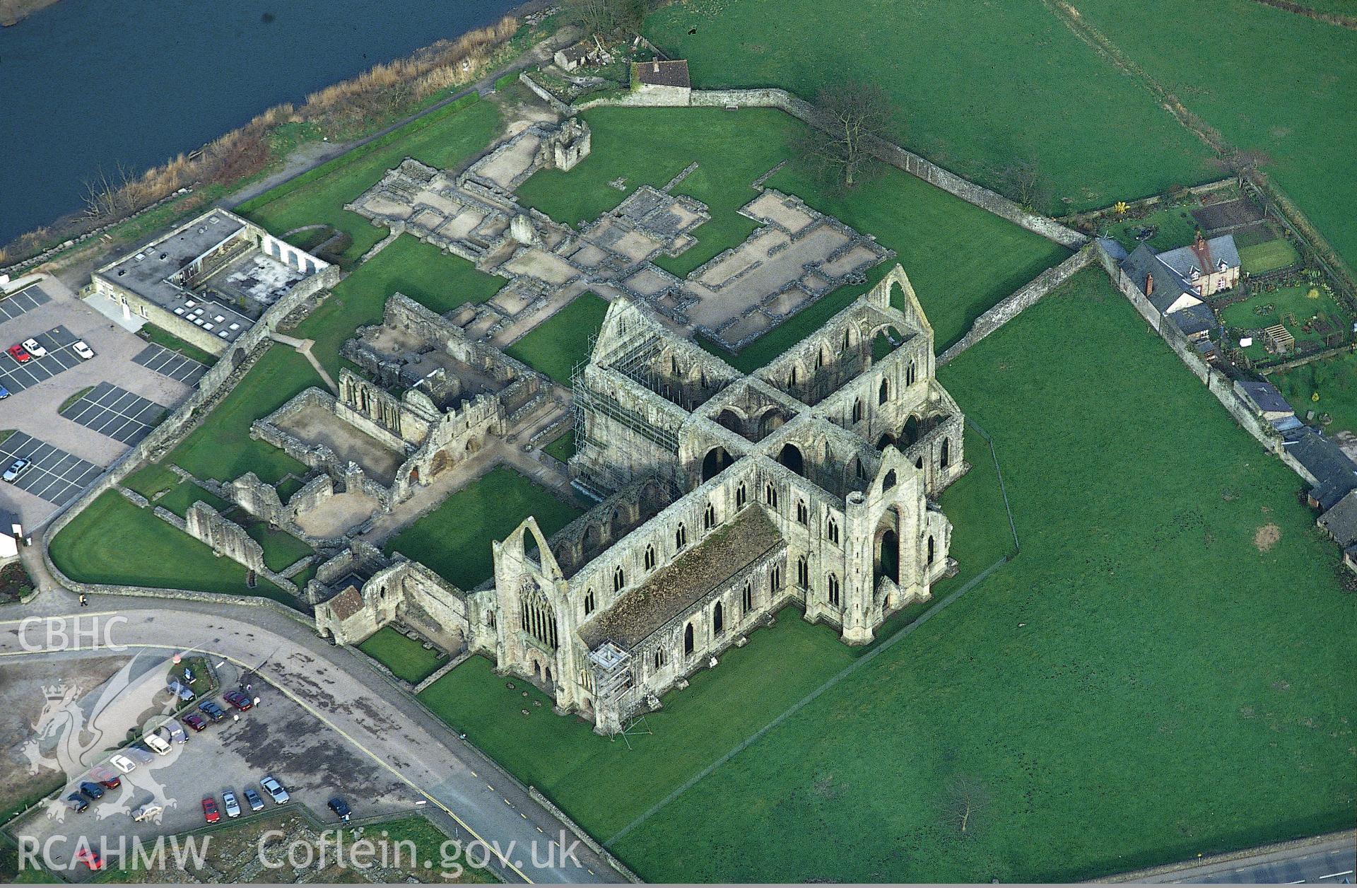 RCAHMW colour slide oblique aerial photograph of Tintern Abbey, Tintern, taken by C.R. Musson, 24/03/94
