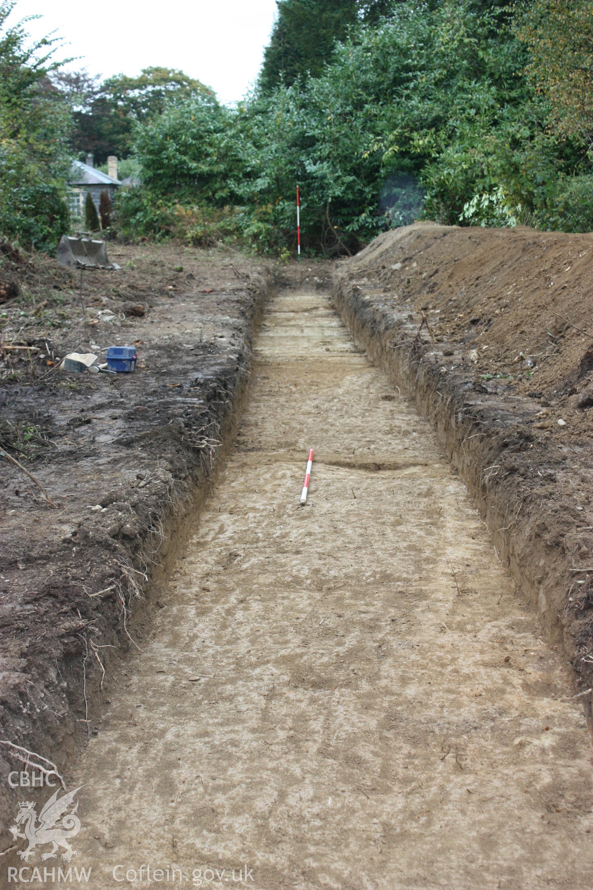 Digital photograph showing Trench 1 with linear feature [005] looking NE - part of archaeological field evaluation at Trawscoed Mansion, Trawscoed, produced by Cambrian Archaeological Projects Ltd.