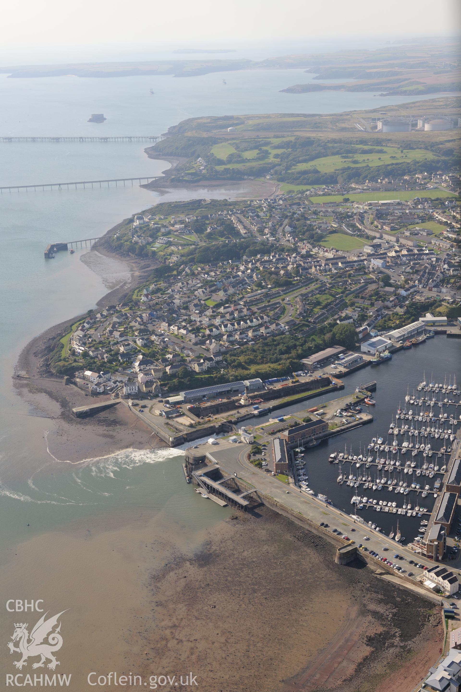 View of Milford Haven town and docks taken from the south east. Oblique aerial photograph taken during the Royal Commission's programme of archaeological aerial reconnaissance by Toby Driver on 30th September 2015.