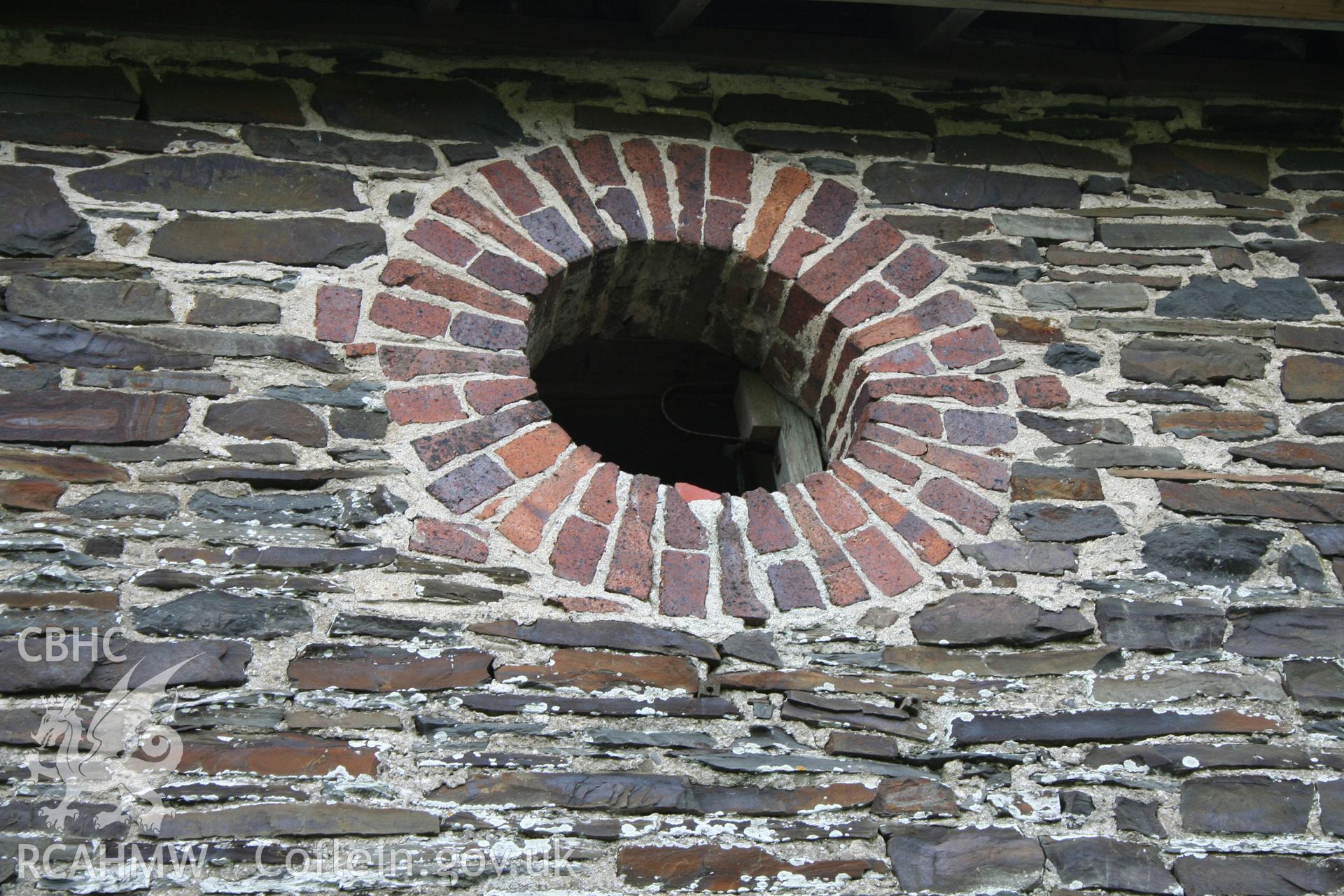 Exterior view of stone wall and window opening supported by engineering brick. Photographic survey of the northern range of cattle-shelters at Tan-y-Graig Farm, Llanfarian, conducted by Geoff Ward and John Wiles, 11th December 2006.