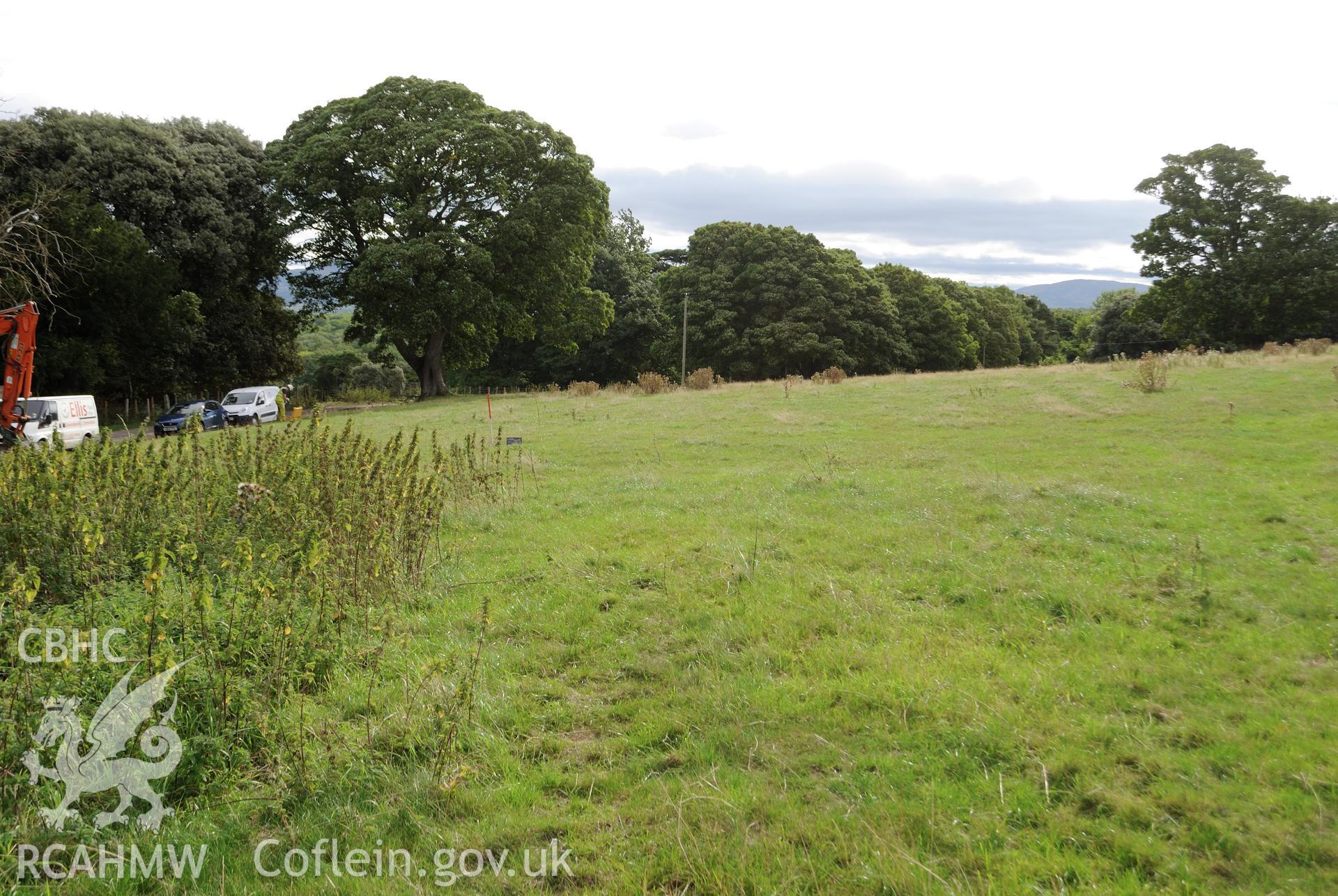 Wide angle view from west of evaluation area pre-excavation, with garden boundary wall to the north. Photographed during archaeological evaluation of Kinmel Park, Abergele, conducted by Gwynedd Archaeological Trust on 22nd August 2018. Project no. 2571.