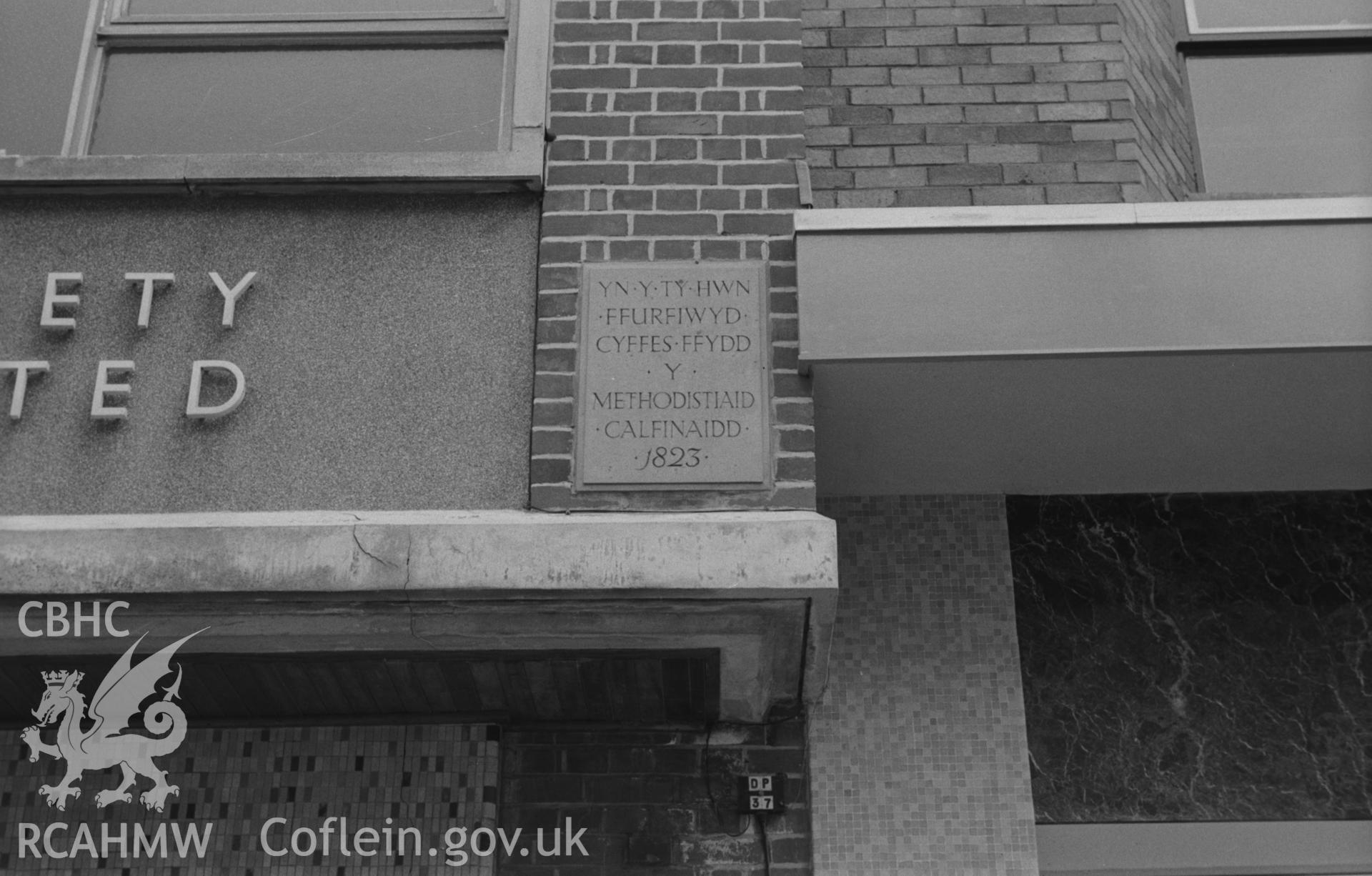 Digital copy of black & white negative showing plaque commemorating formation of Calvinistic Methodists (1823) above new Cooperate Society shop, east side of Great Darkgate St, Aberystwyth. Photograph by Arthur Chater, 15/8/1967 looking S.E. from SN583817.