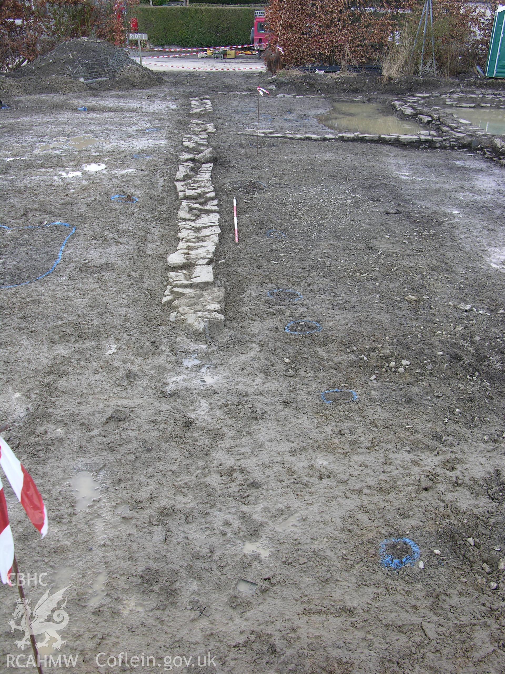 Colour digital photograph showing view of 'enclosure' wall projecting eastwards from post medieval structure - part of the Archaeological Excavation report for Horse Yard Farm, Evenjobb (CAP Report 607) by Chris E Smith, from a Cambrian Archaeological Projects assessment survey.