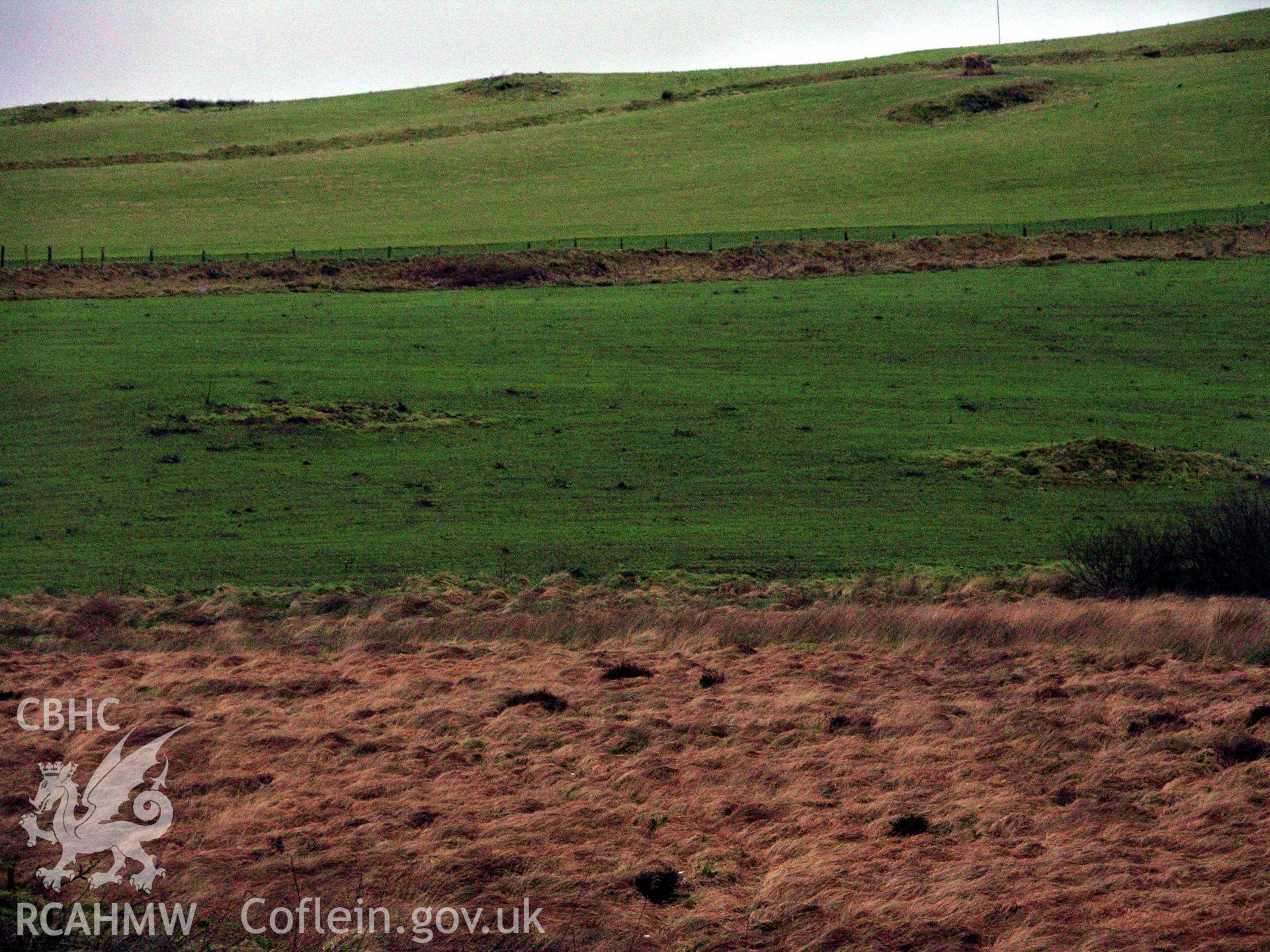 Colour digital photograph showing view of numerous clearance cairns and natural knolls in fields surrounding Carneddau - part of archaeological desk based assessment for Esgair Cwmowen, Carno (CAP Report 549).