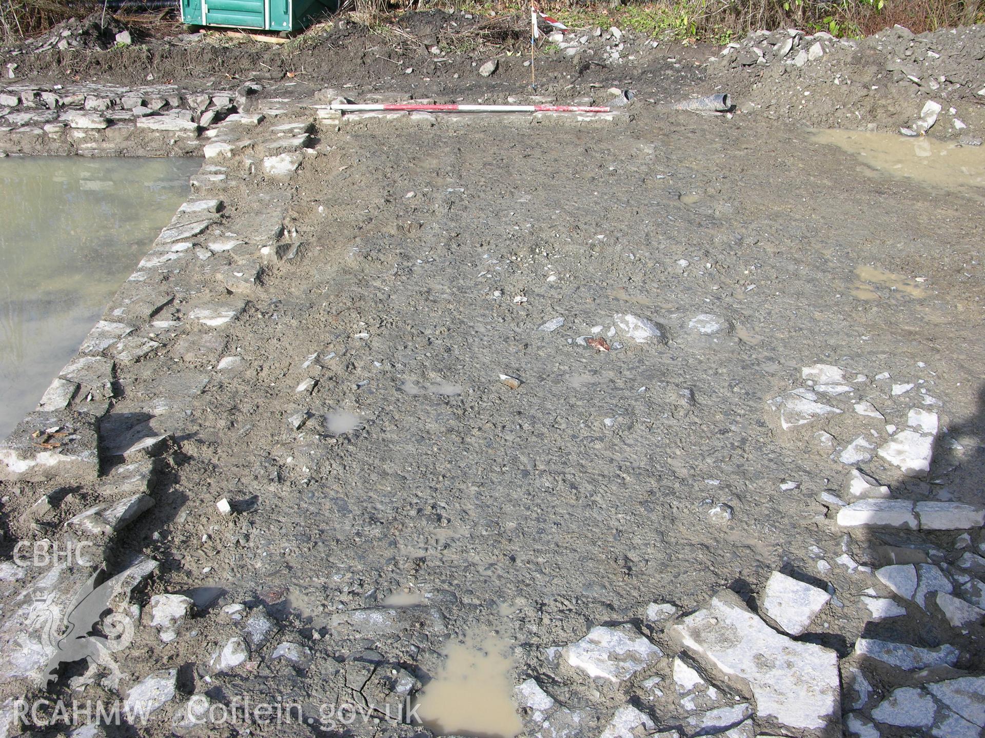 Colour digital photograph showing view of partially cobbled/partially rammed floor - part of the Archaeological Excavation report for Horse Yard Farm, Evenjobb (CAP Report 607) by Chris E Smith, from a Cambrian Archaeological Projects assessment survey.