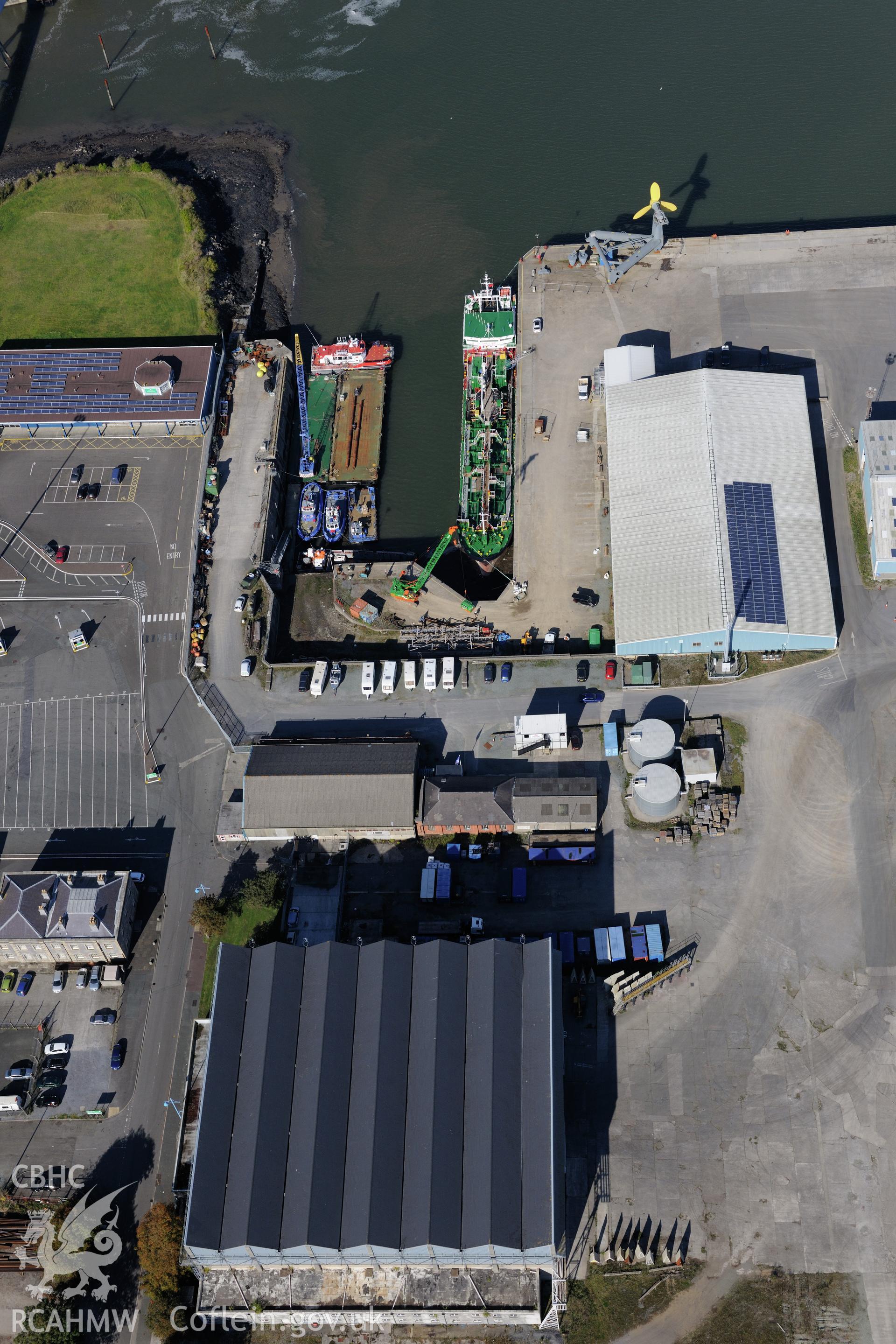 Pembroke Dockyard including view of the slipways at docks 8 to 11 and the west hangar of the flying boat station. Oblique aerial photograph taken during the Royal Commission's programme of archaeological aerial reconnaissance by Toby Driver on 30th September 2015.