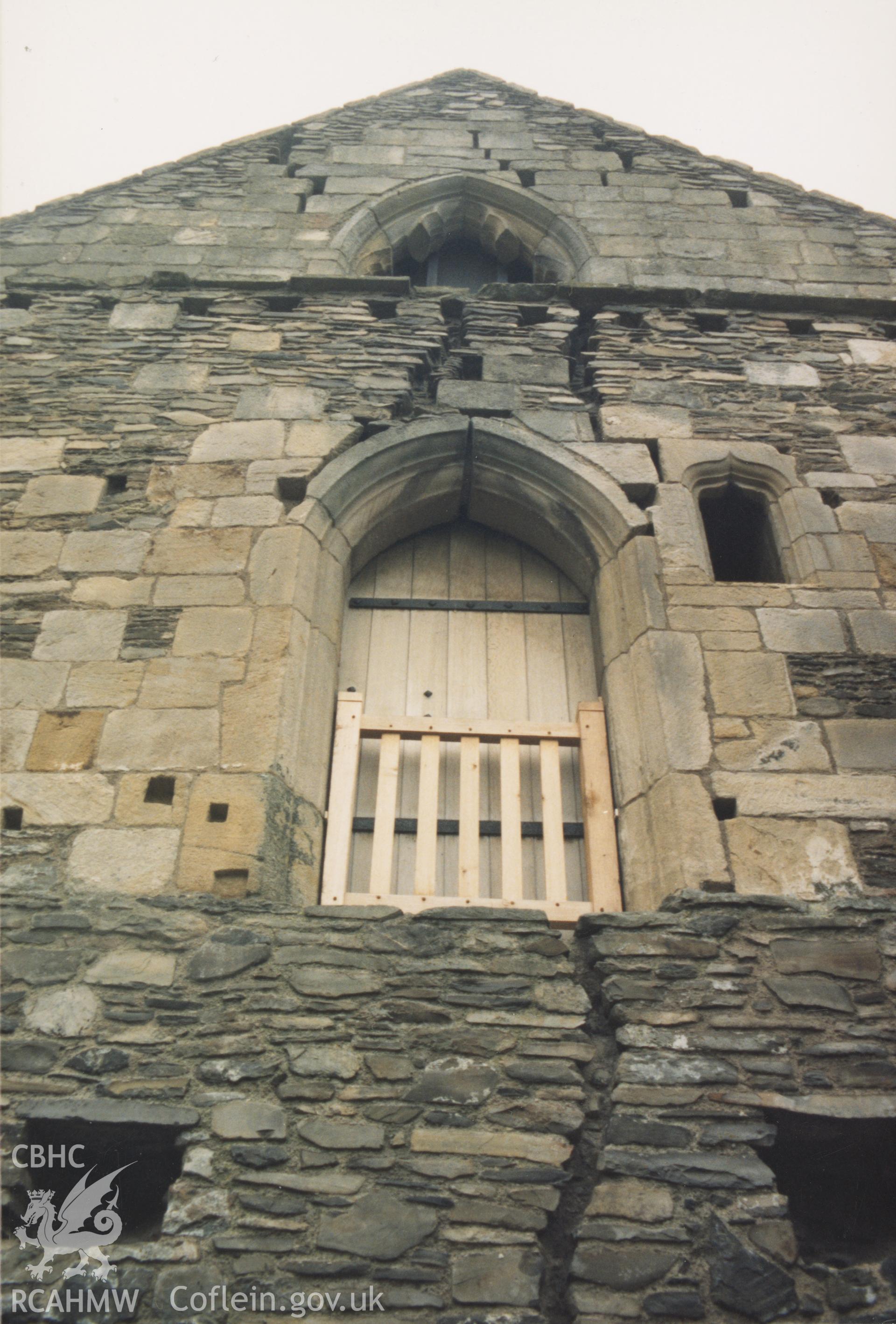 Digitised copy of a colour photograph showing cracks in south facing wall to dormitory at Valle Crucis Abbey, taken by Cadw c.1989.