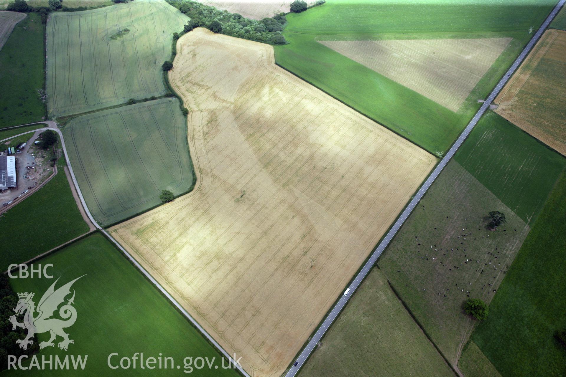 RCAHMW colour oblique photograph of Gerwyn-Fechan round barrow and other cropmarks. Taken by Toby Driver and Oliver Davies on 05/07/2011.
