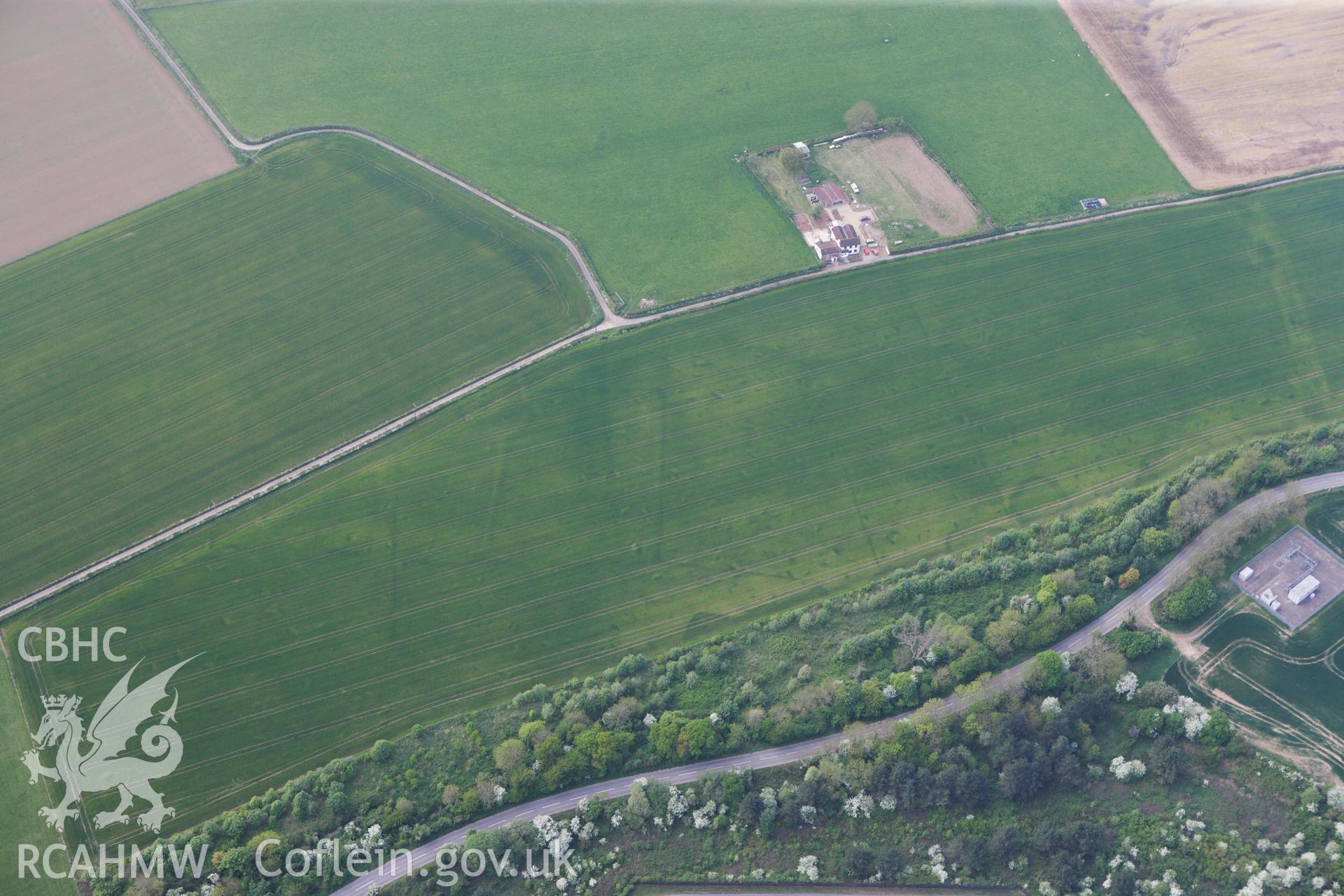 RCAHMW colour oblique photograph of Trewen enclosure complex, cropmarks. Taken by Toby Driver on 26/04/2011.