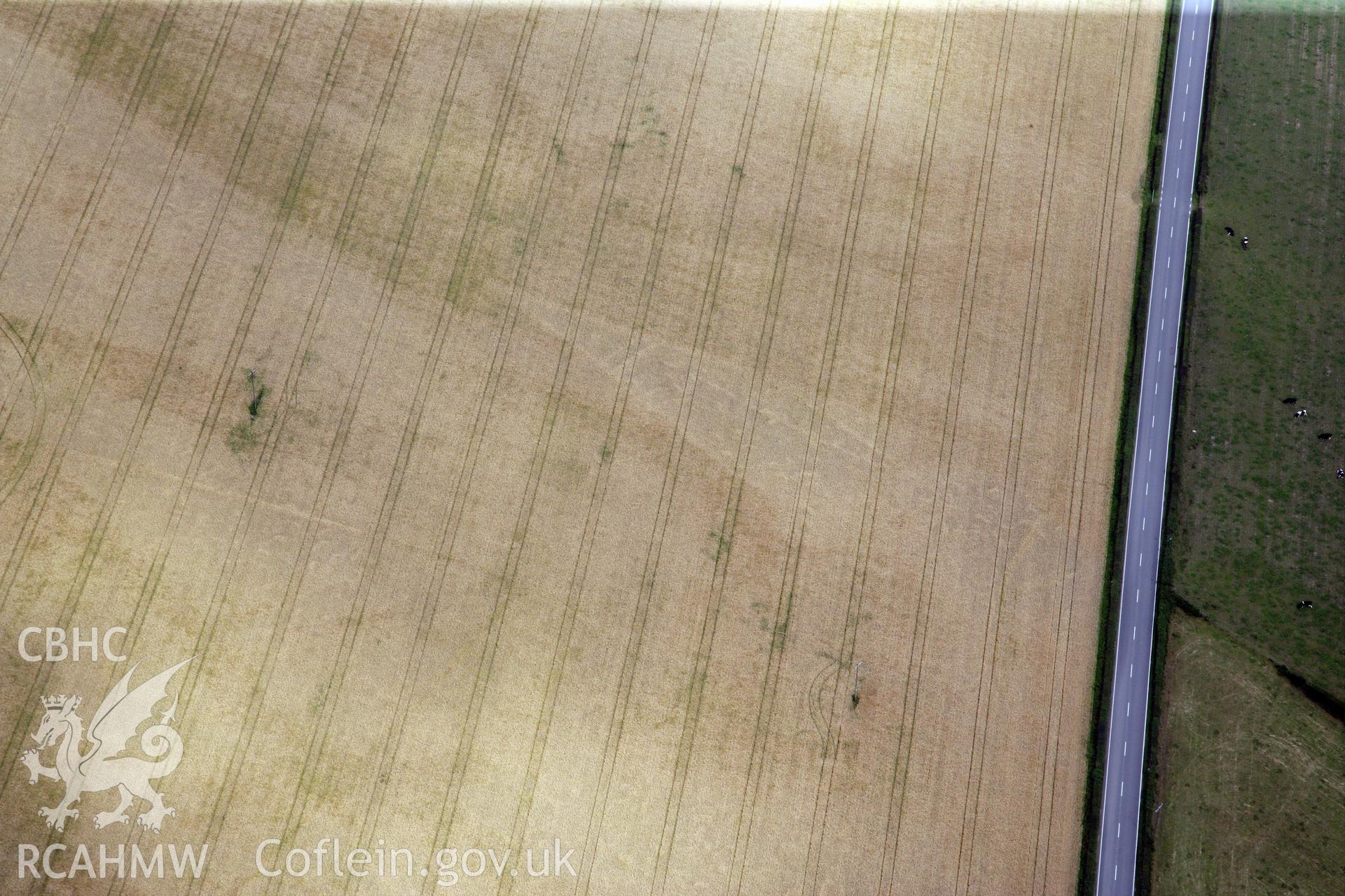 RCAHMW colour oblique photograph of Gerwyn-Fechan round barrow and other cropmarks. Taken by Toby Driver and Oliver Davies on 05/07/2011.