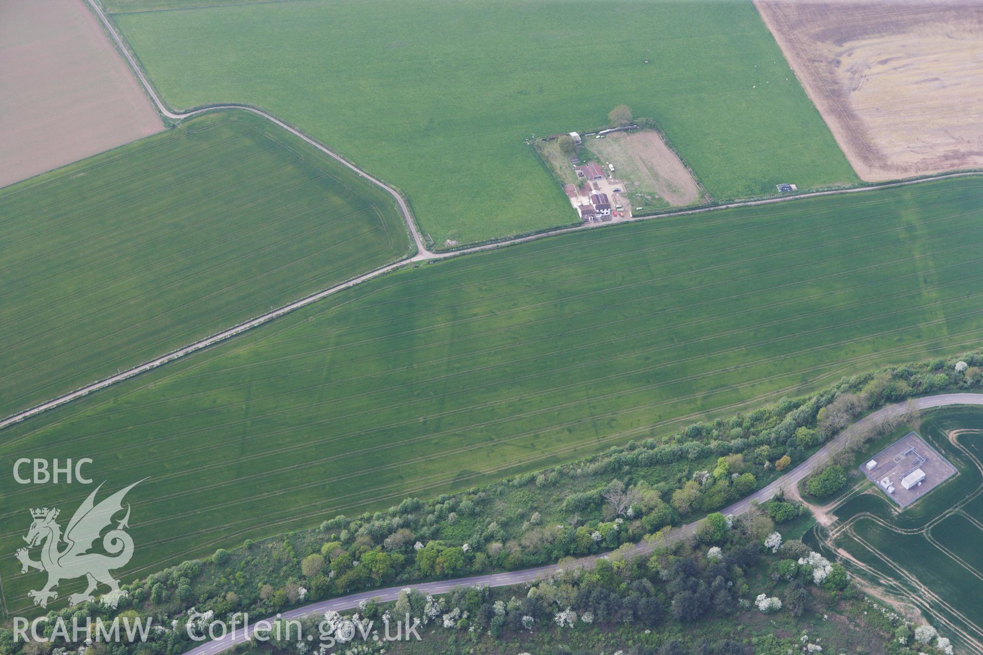 RCAHMW colour oblique photograph of Trewen enclosure complex, cropmarks. Taken by Toby Driver on 26/04/2011.