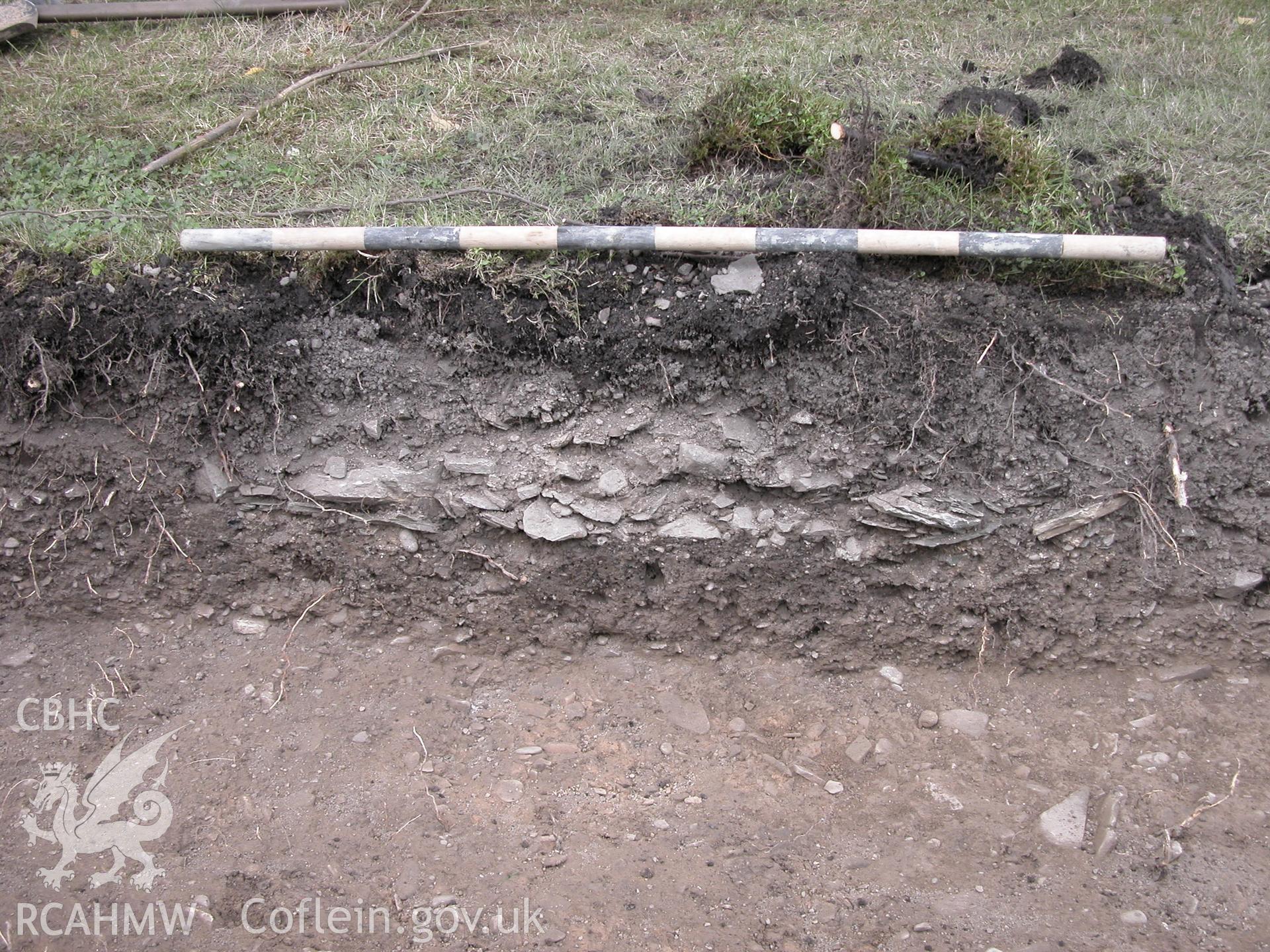 Digital photograph captioned: 'Section of feature (105), Scale 1x1m' plate 1 of Archaeological Watching Brief and Desk Based Assessment for the Old Bowling Green, Cannons Lane, Presteigne. CAP Report Number 653.