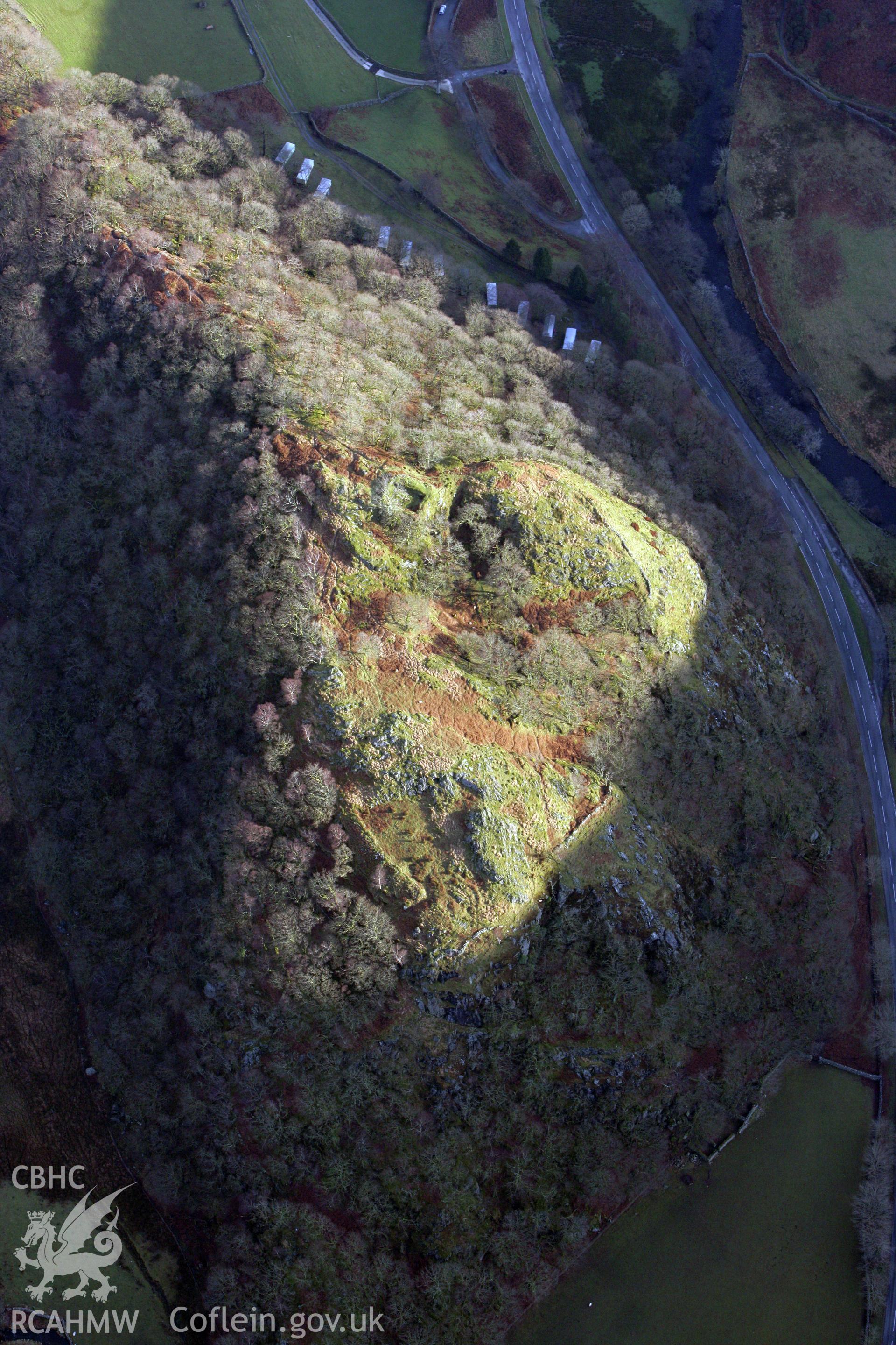 RCAHMW colour oblique photograph of Dinas Emrys castle, with castle illuminated by winter sunlight. Taken by Toby Driver on 13/01/2012.