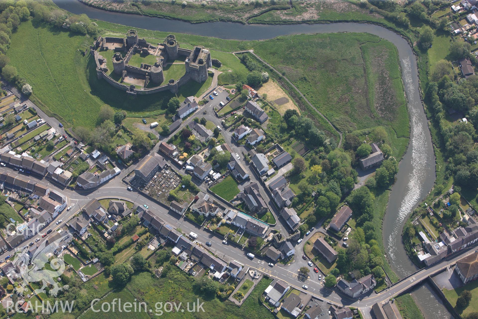 RCAHMW colour oblique photograph of General view of Kidwelly medieval town and Kidwelly Castle, looking east. Taken by Toby Driver on 24/05/2012.