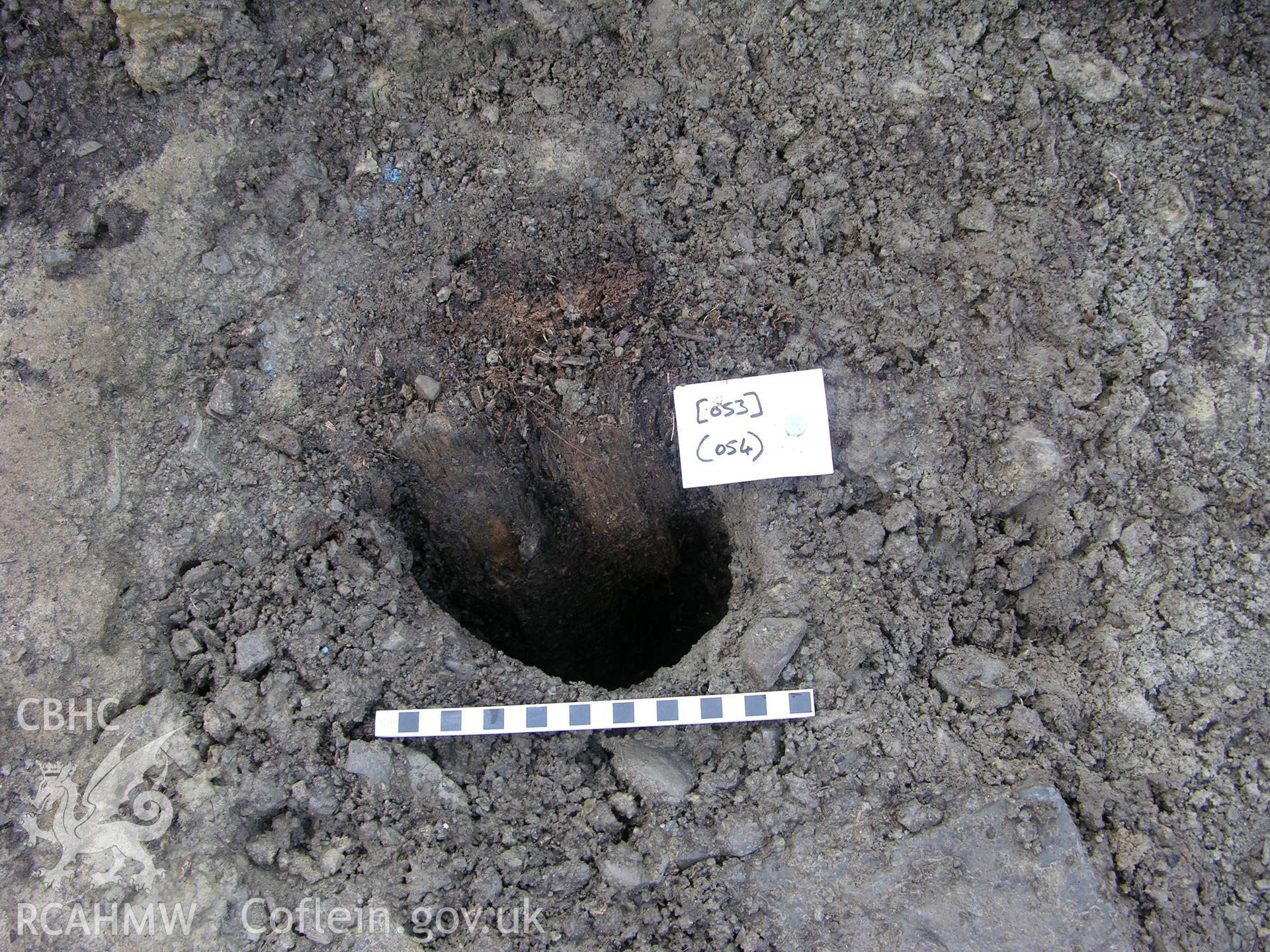 Colour digital photograph showing view of posthole with post - part of the Archaeological Excavation report for Horse Yard Farm, Evenjobb (CAP Report 607) by Chris E Smith, from a Cambrian Archaeological Projects assessment survey.