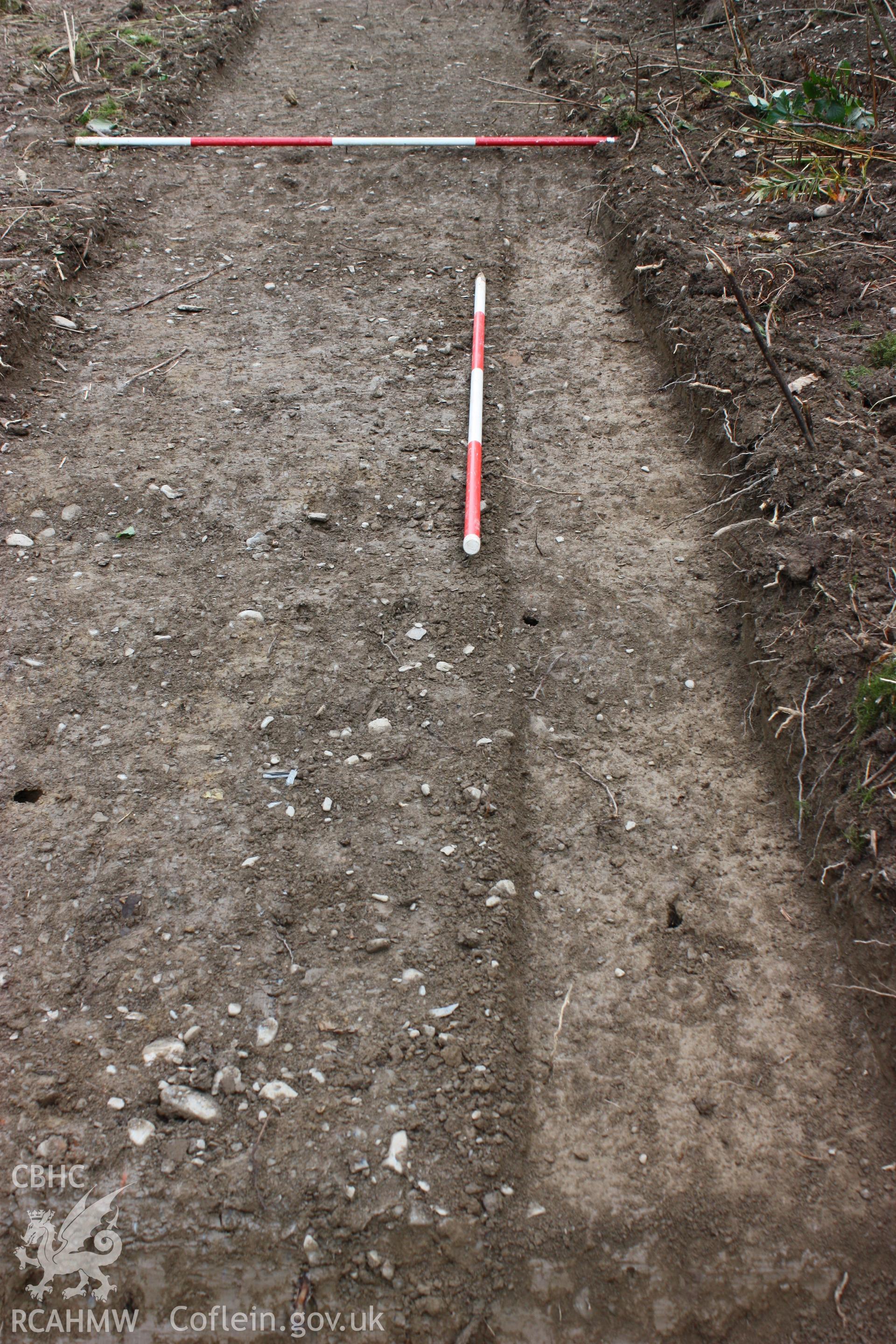 Digital photograph showing road slump deposit (002) with road [001] to NE (top) - part of archaeological field evaluation at Trawscoed Mansion, Trawscoed, produced by Cambrian Archaeological Projects Ltd.