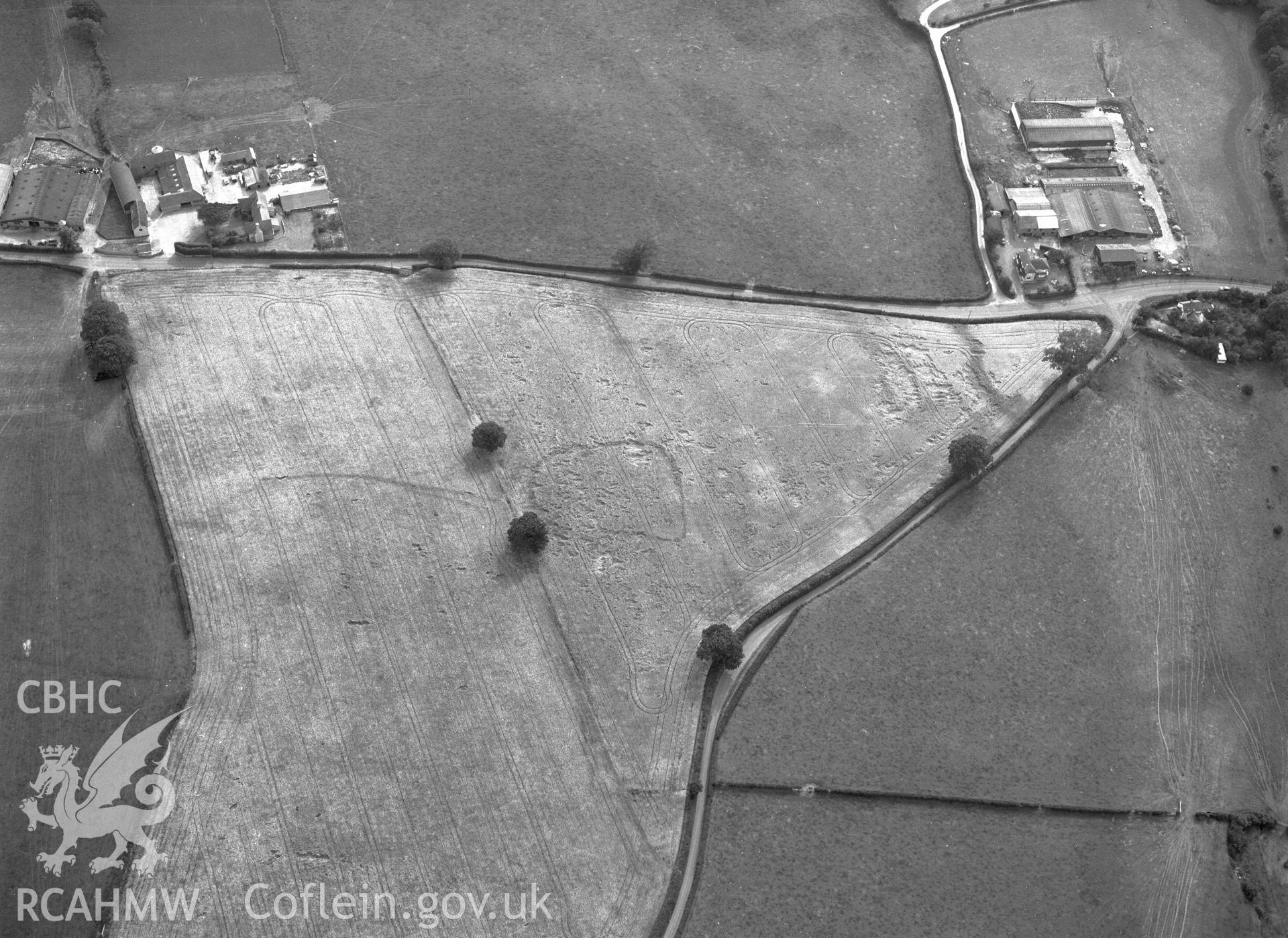 RCAHMW black and white oblique aerial photograph of cropmark enclosure SE of Rhydonnen, taken by C R Musson, 22/07/1996. Digital copy available.