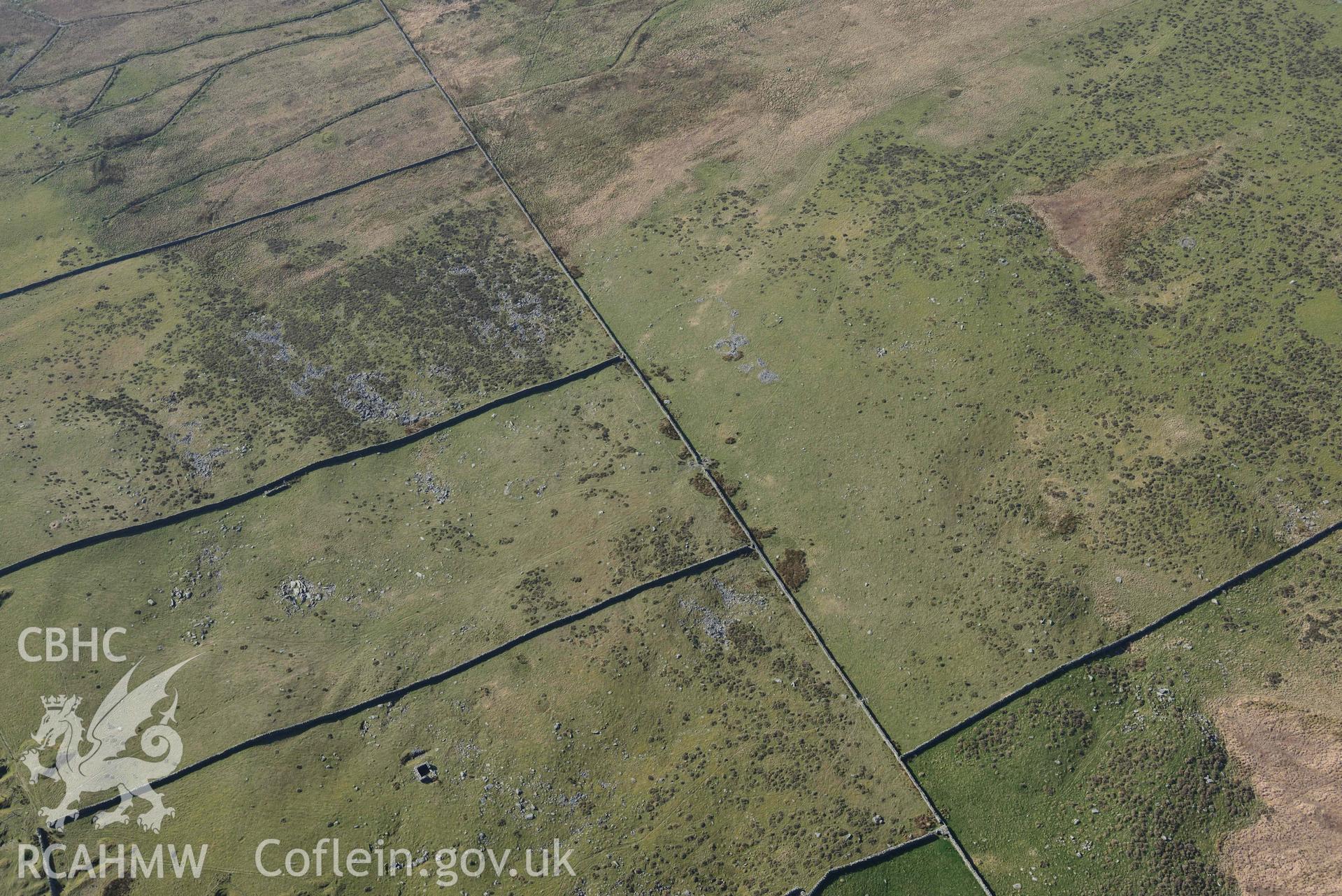 Mynydd Egryn hut circle settlement, wide view from northeast. Oblique aerial photographs taken during the Royal Commission’s programme of archaeological aerial reconnaissance by Toby Driver on 25 March 2022.