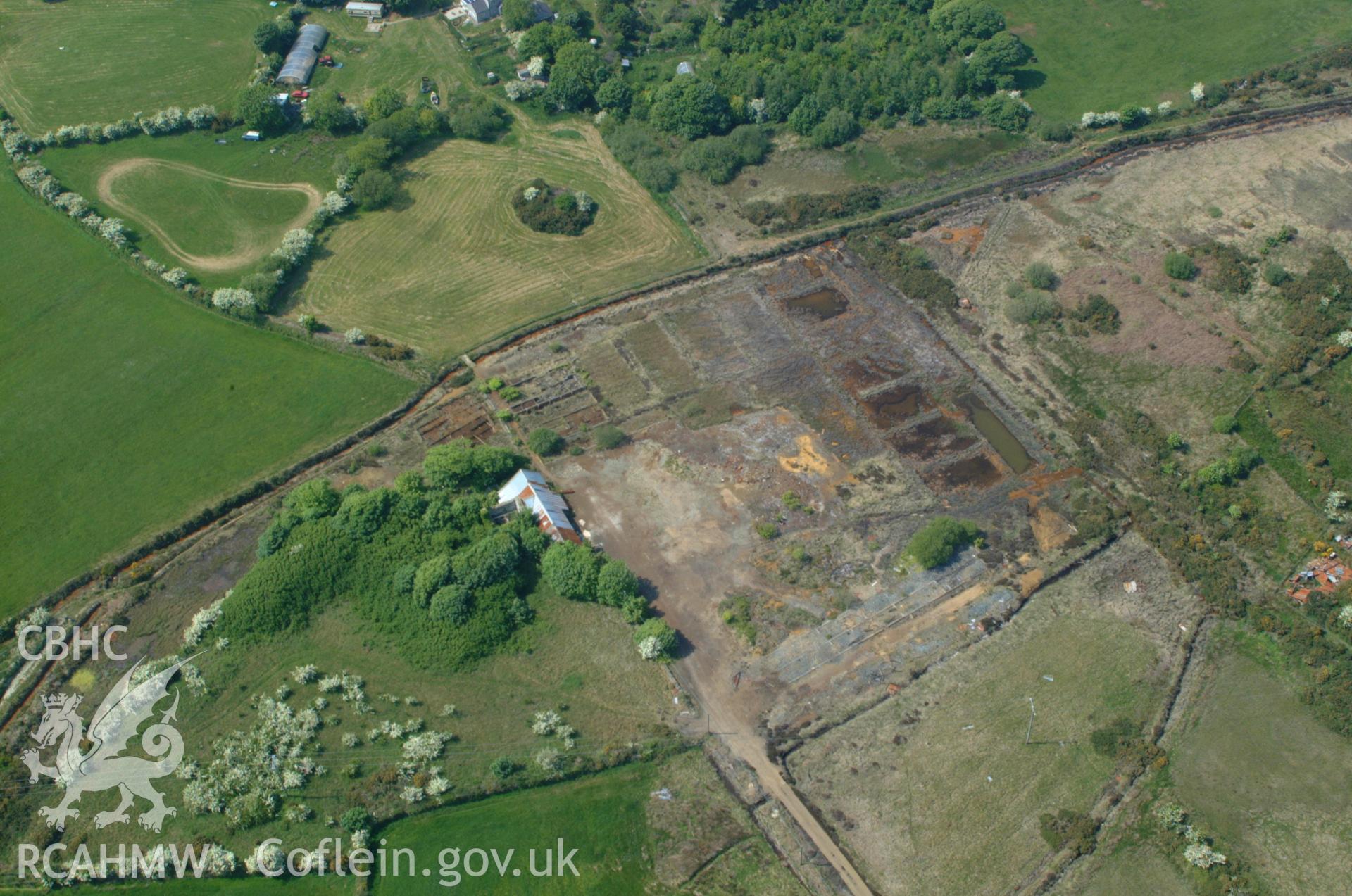RCAHMW colour oblique aerial photograph of Dyffryn Adda Reverbatory Furnace, Parys Mountain taken on 26/05/2004 by Toby Driver