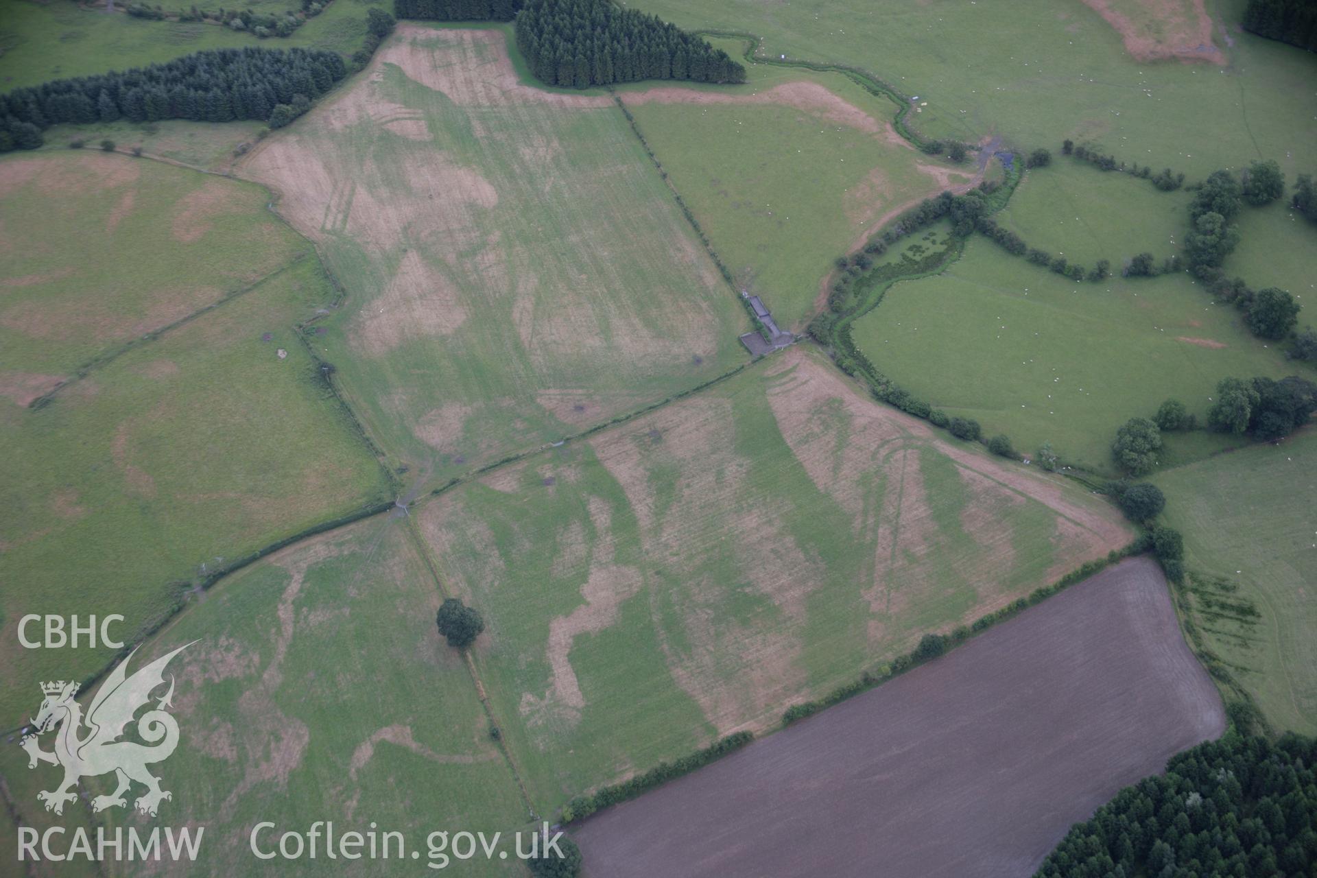 RCAHMW colour oblique aerial photograph of Llanfor Roman Military Complex visible in cropmarks, in general view from the north-west. Taken on 31 July 2006 by Toby Driver.