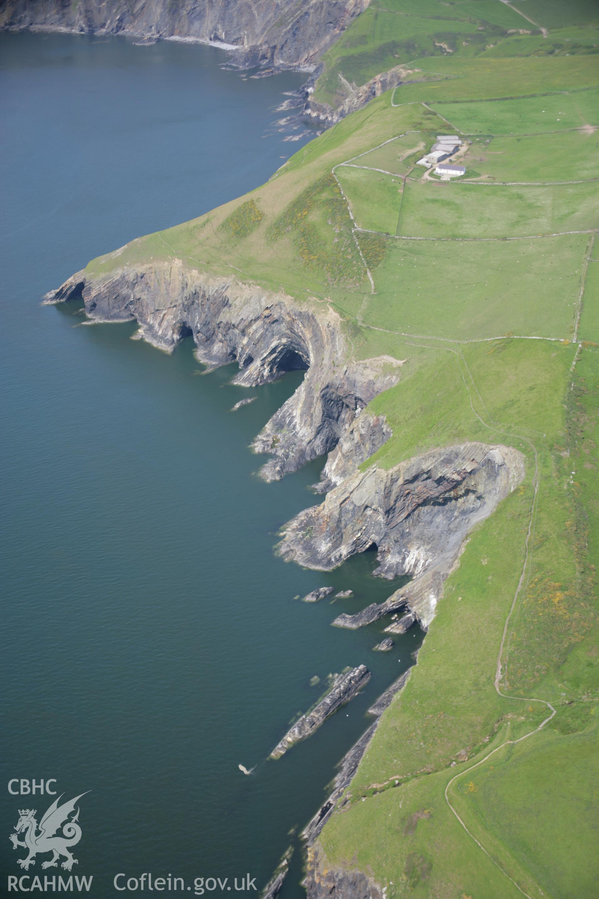 RCAHMW colour oblique aerial photograph of the Pembrokeshire Coast Path between Ceibwr Bay and Foel Hendre, from the south-west and showing the geology of the area. Taken on 08 June 2006 by Toby Driver.