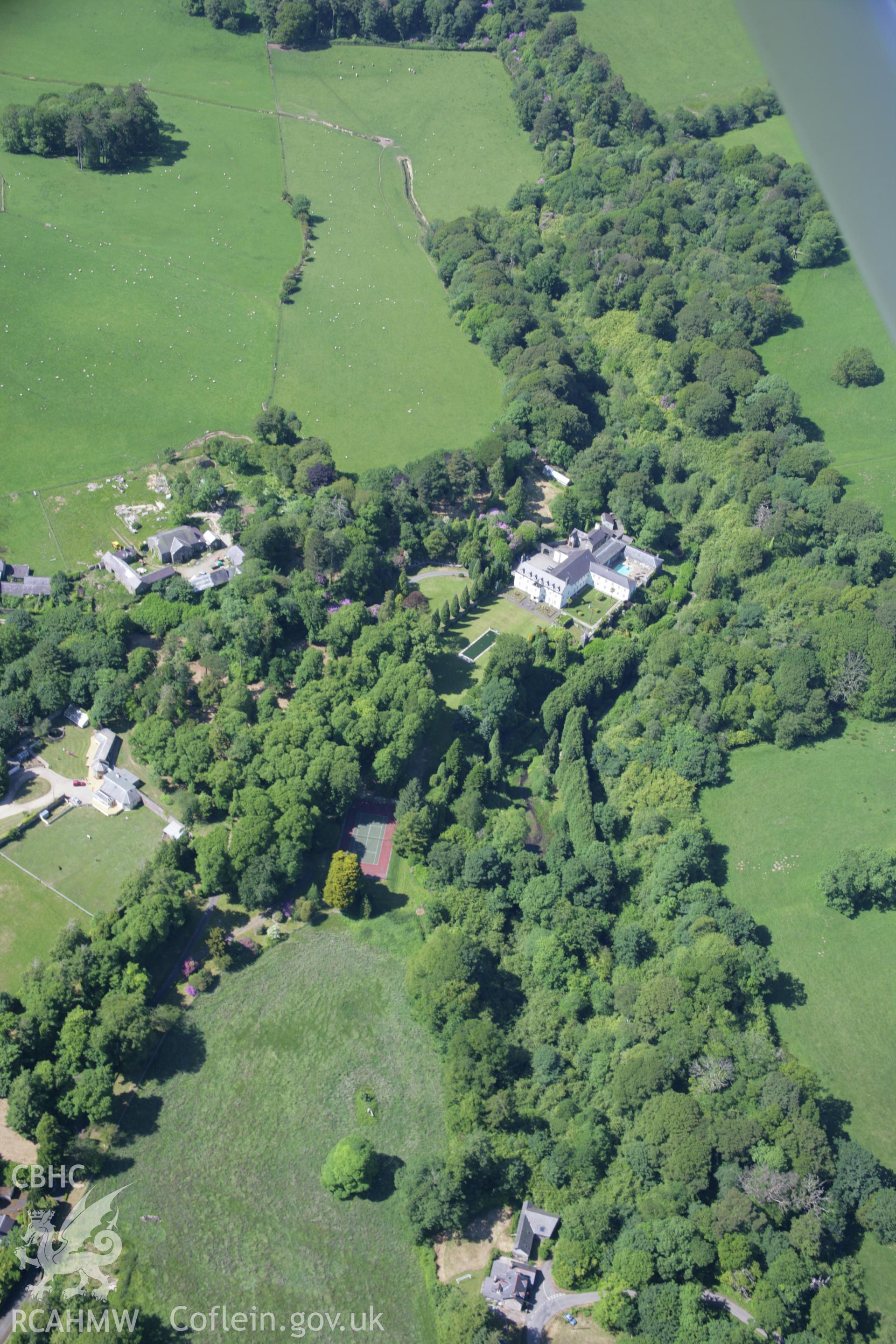 RCAHMW colour oblique aerial photograph of the park, grounds and gardens of Bodfean Hall. A view of the landscape from the south-east. Taken on 14 June 2006 by Toby Driver.