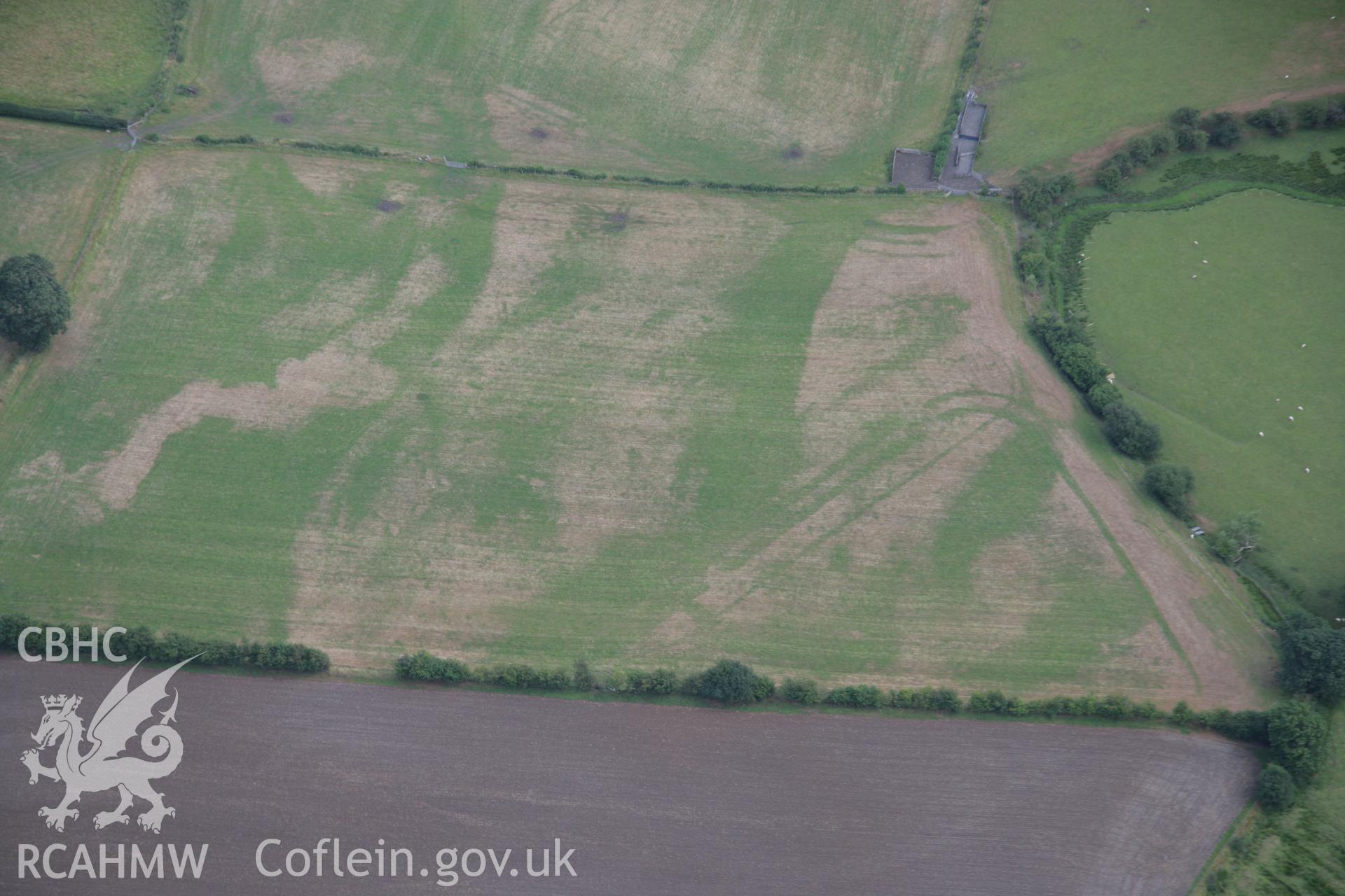 RCAHMW colour oblique aerial photograph of Llanfor Roman Military Complex visible in cropmarks, viewed from the north-west. Taken on 31 July 2006 by Toby Driver.