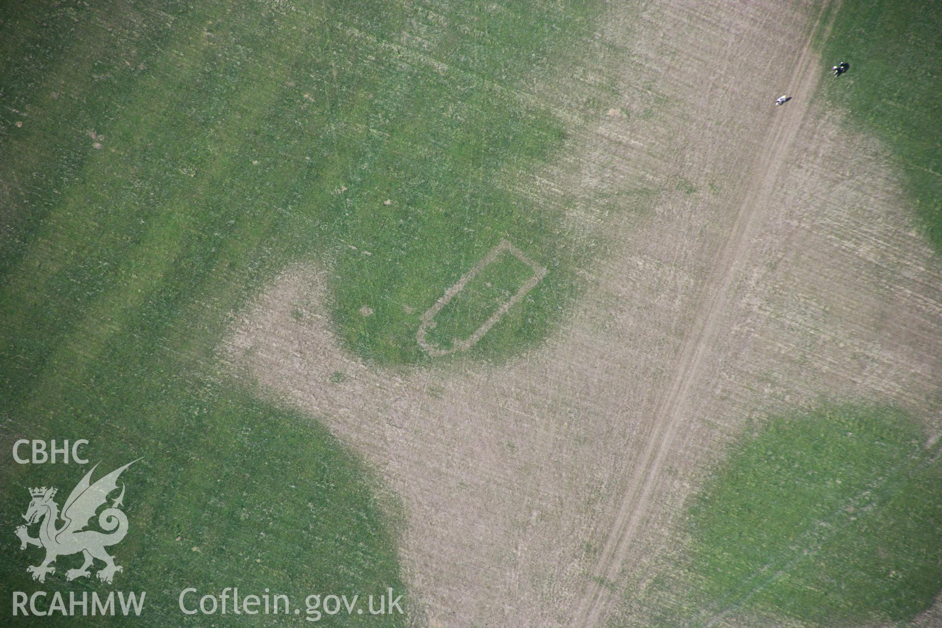 RCAHMW colour oblique aerial photograph of Llwydfaen Medieval Township, site of buried medieval church, view of parched foundations and wider township, from south, taken on 14/08/2006 by Toby Driver.