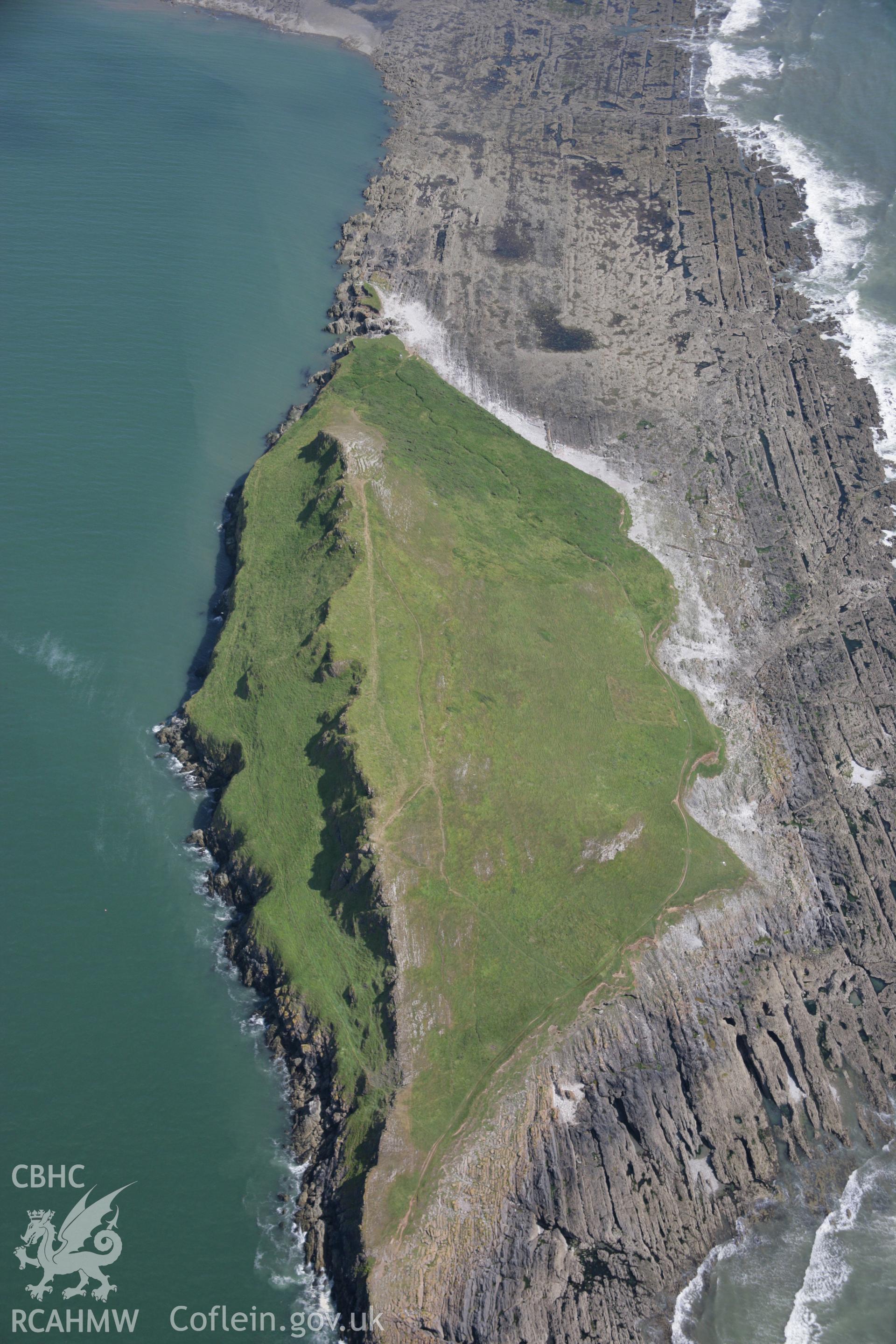 RCAHMW colour oblique aerial photograph of Worms Head and the defended enclosure. Taken on 11 July 2006 by Toby Driver.