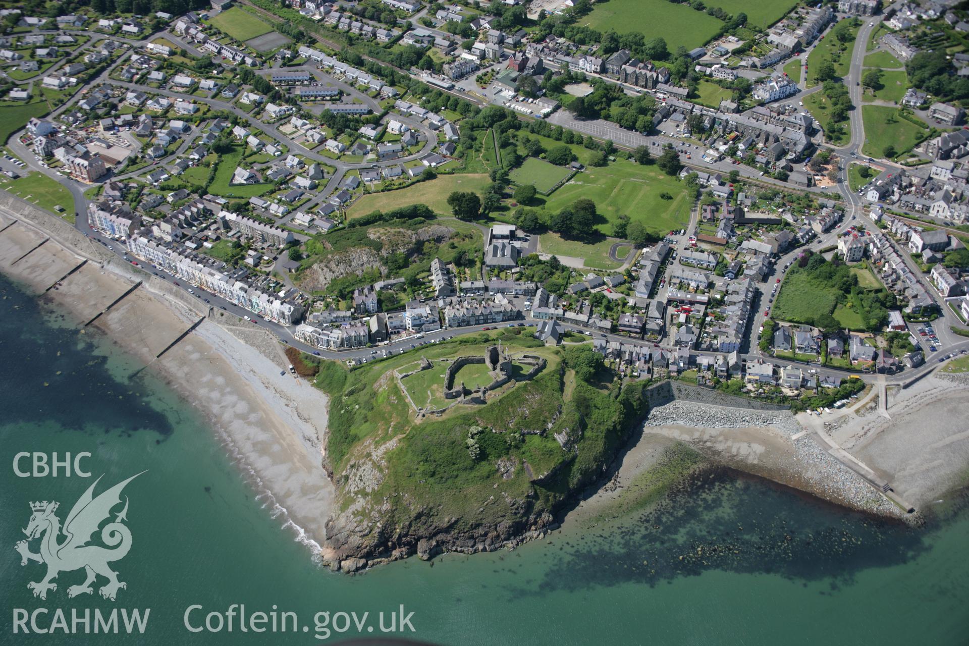 RCAHMW colour oblique aerial photograph of Criccieth Castle and the town from the south. Taken on 14 June 2006 by Toby Driver.