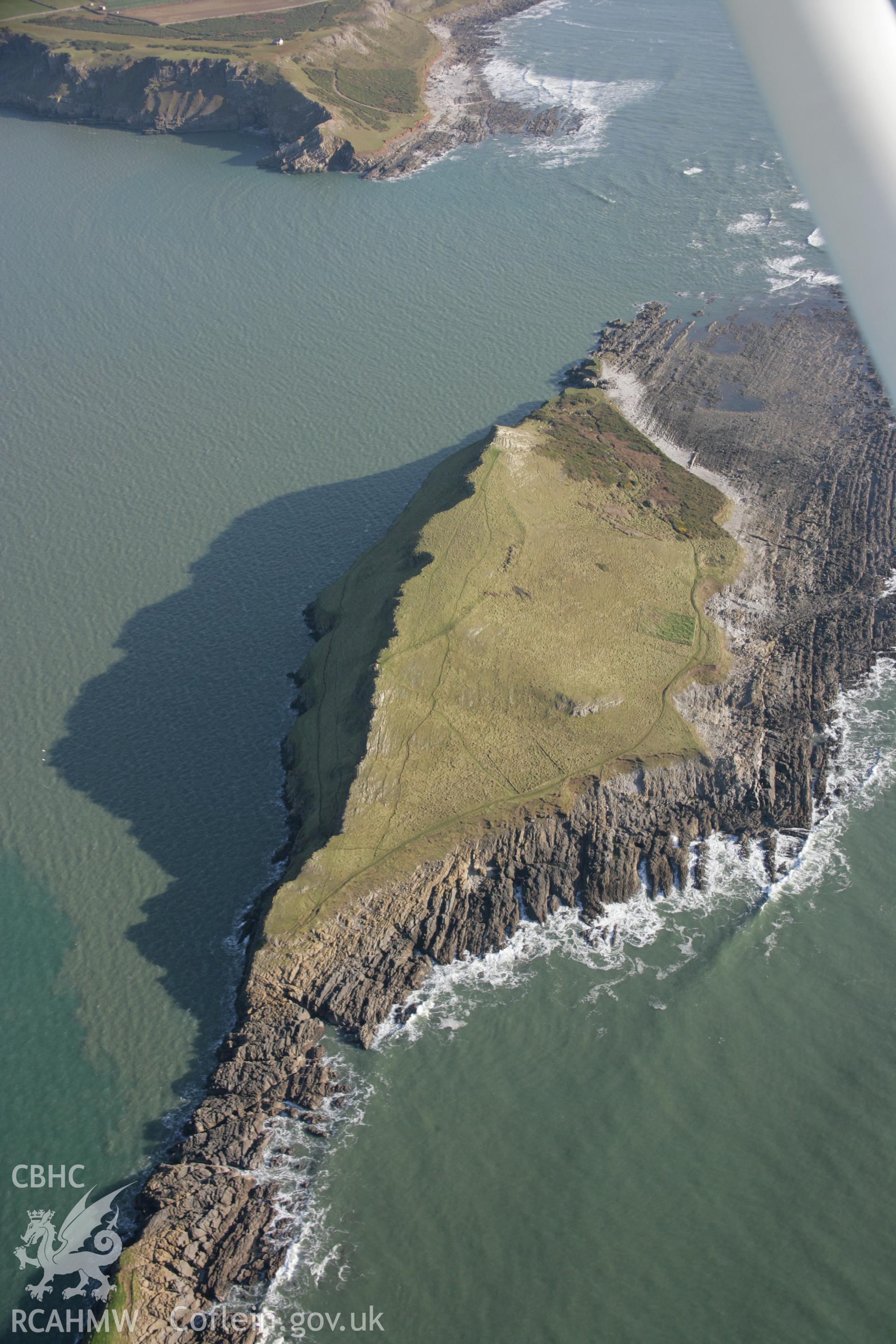 RCAHMW colour oblique aerial photograph of Worms Head Enclosure from the north-west. Taken on 26 January 2006 by Toby Driver.