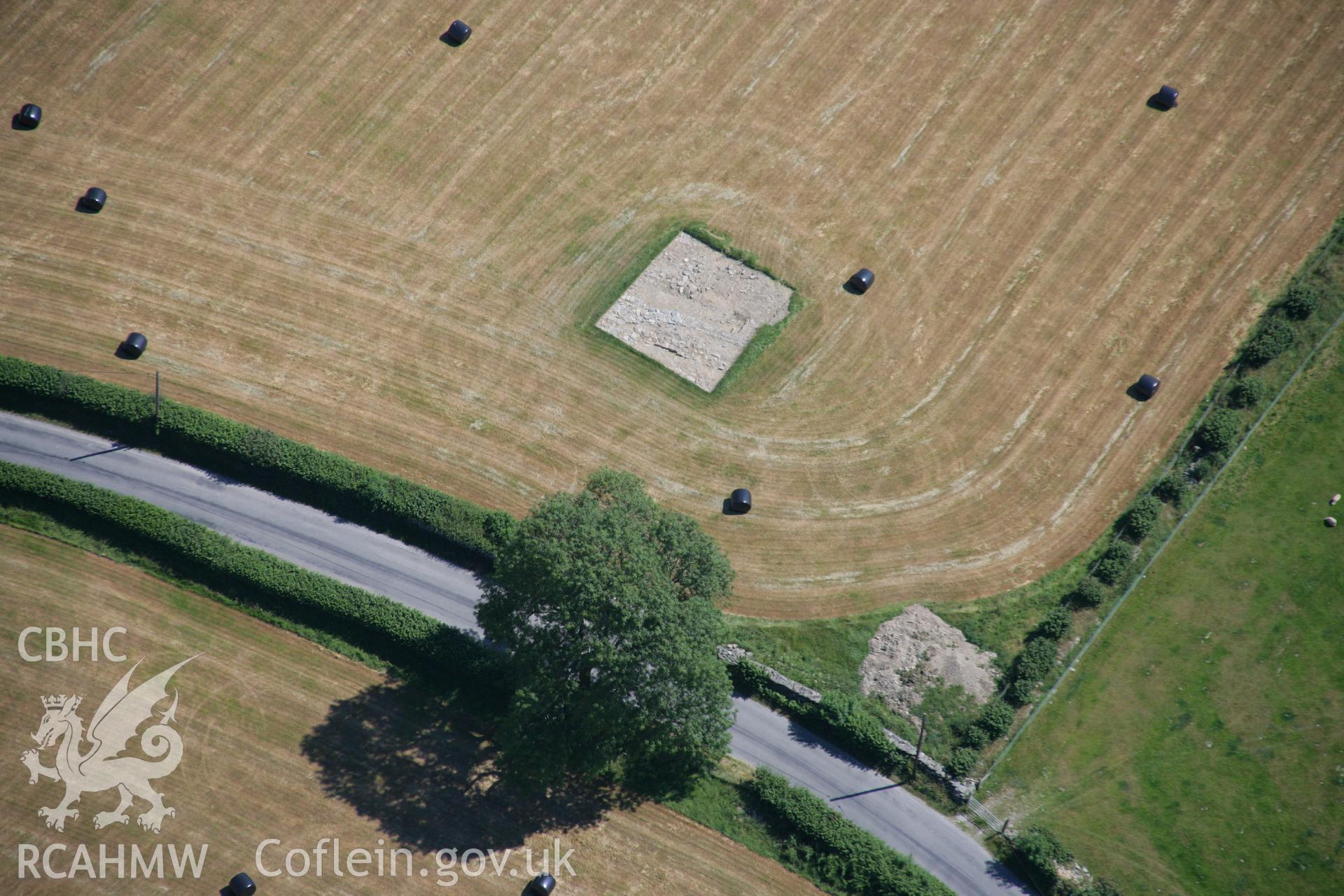 RCAHMW colour oblique aerial photograph of the gatehouse of the Strata Florida Abbey Precinct showing excavations. Taken on 17 July 2006 by Toby Driver.