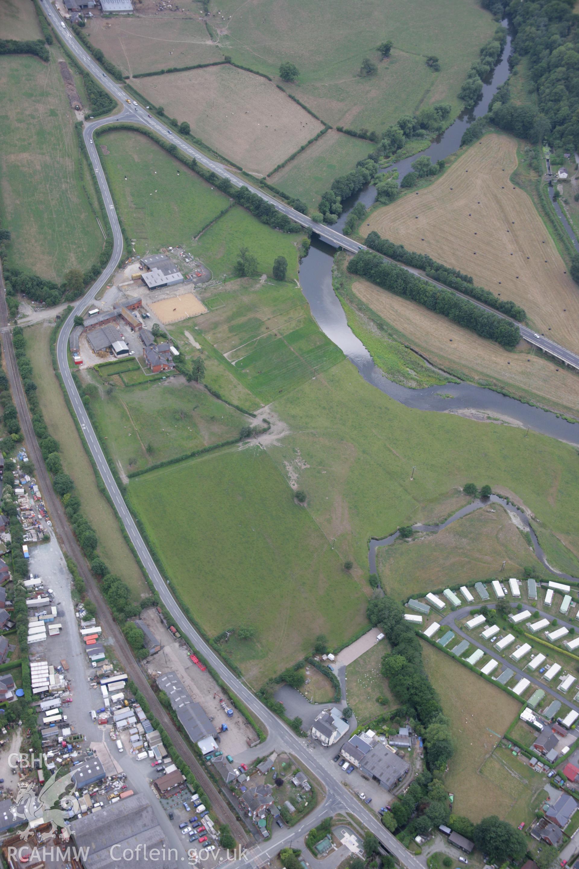 RCAHMW colour oblique aerial photograph of possible cropmarks of a Roman Road at The Court, Abermule. Taken on 14 August 2006 by Toby Driver.