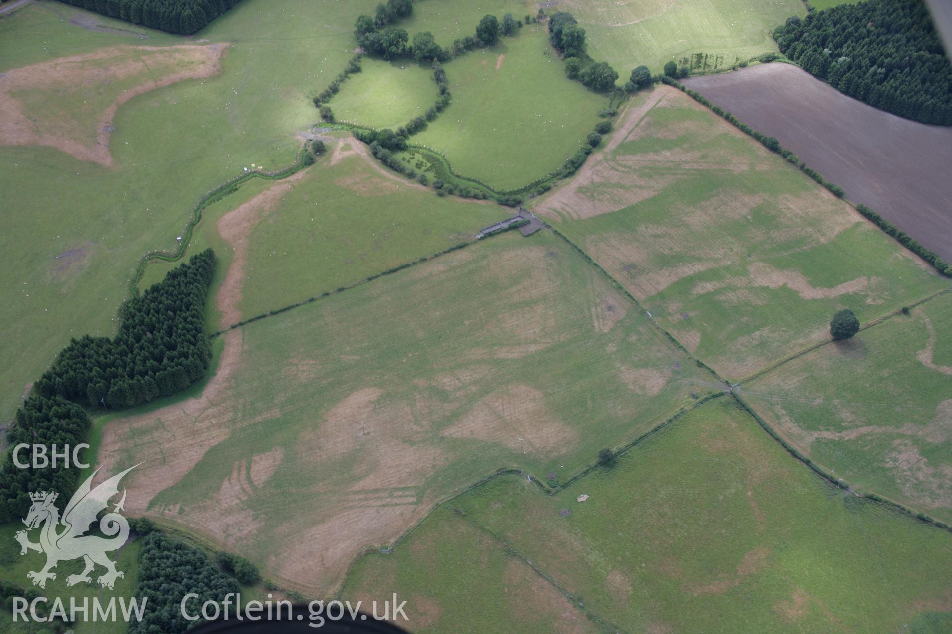 RCAHMW colour oblique aerial photograph of Llanfor Roman Military Complex visible in cropmarks, in general view from the east. Taken on 31 July 2006 by Toby Driver.