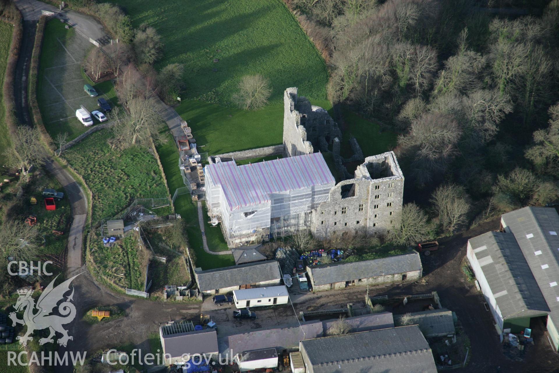 RCAHMW colour oblique aerial photograph of Oxwich Castle, with restoration in progress, in wide view from the south. Taken on 26 January 2006 by Toby Driver.