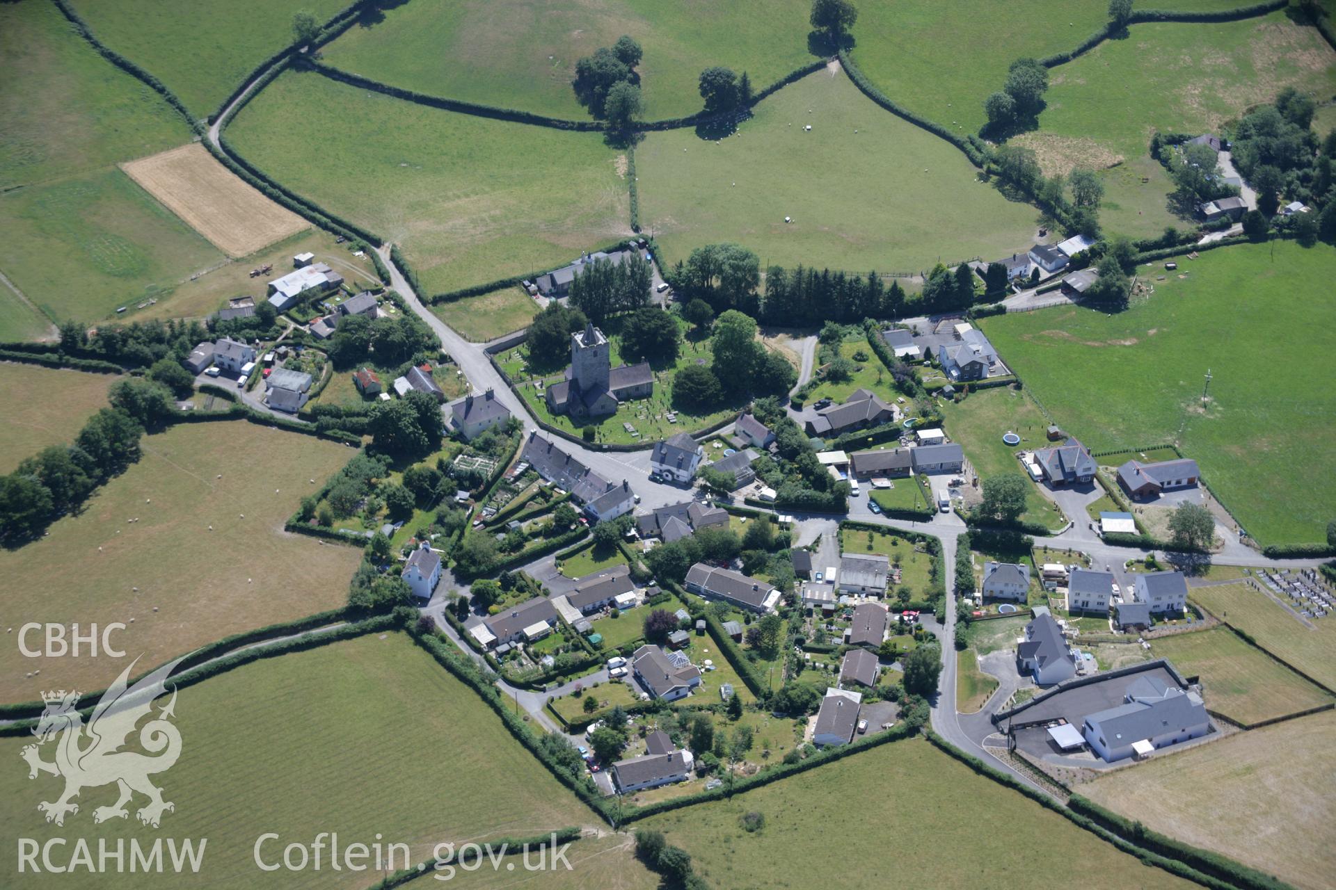 RCAHMW colour oblique aerial photograph of Llanfihangel y Creuddyn village. Taken on 17 July 2006 by Toby Driver.