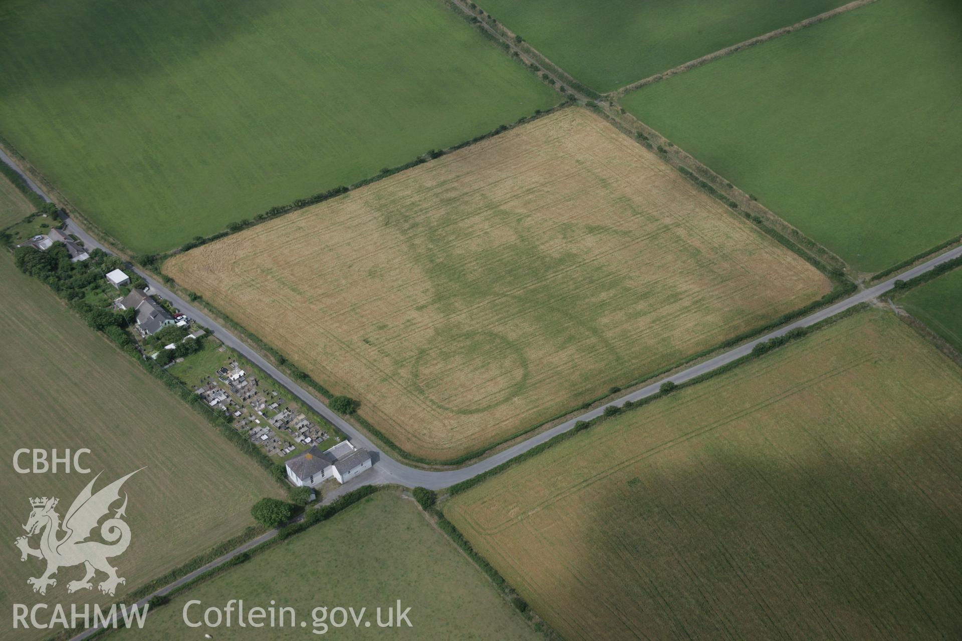 RCAHMW digital colour oblique photograph of a cropmark enclosure east of Treferedd Uchaf viewed from the east. Taken on 27/07/2005 by T.G. Driver.