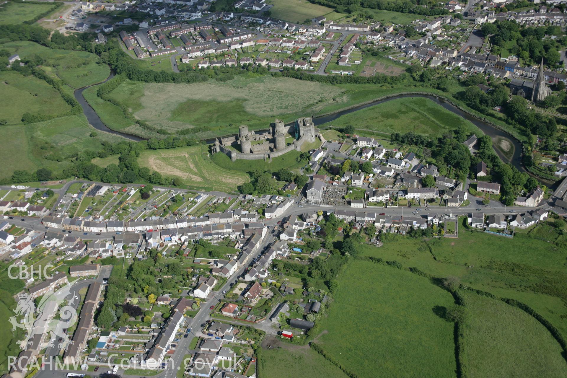 RCAHMW colour oblique aerial photograph of Kidwelly Castle and part of medieval town, viewed from north-west Taken on 09 June 2005 by Toby Driver