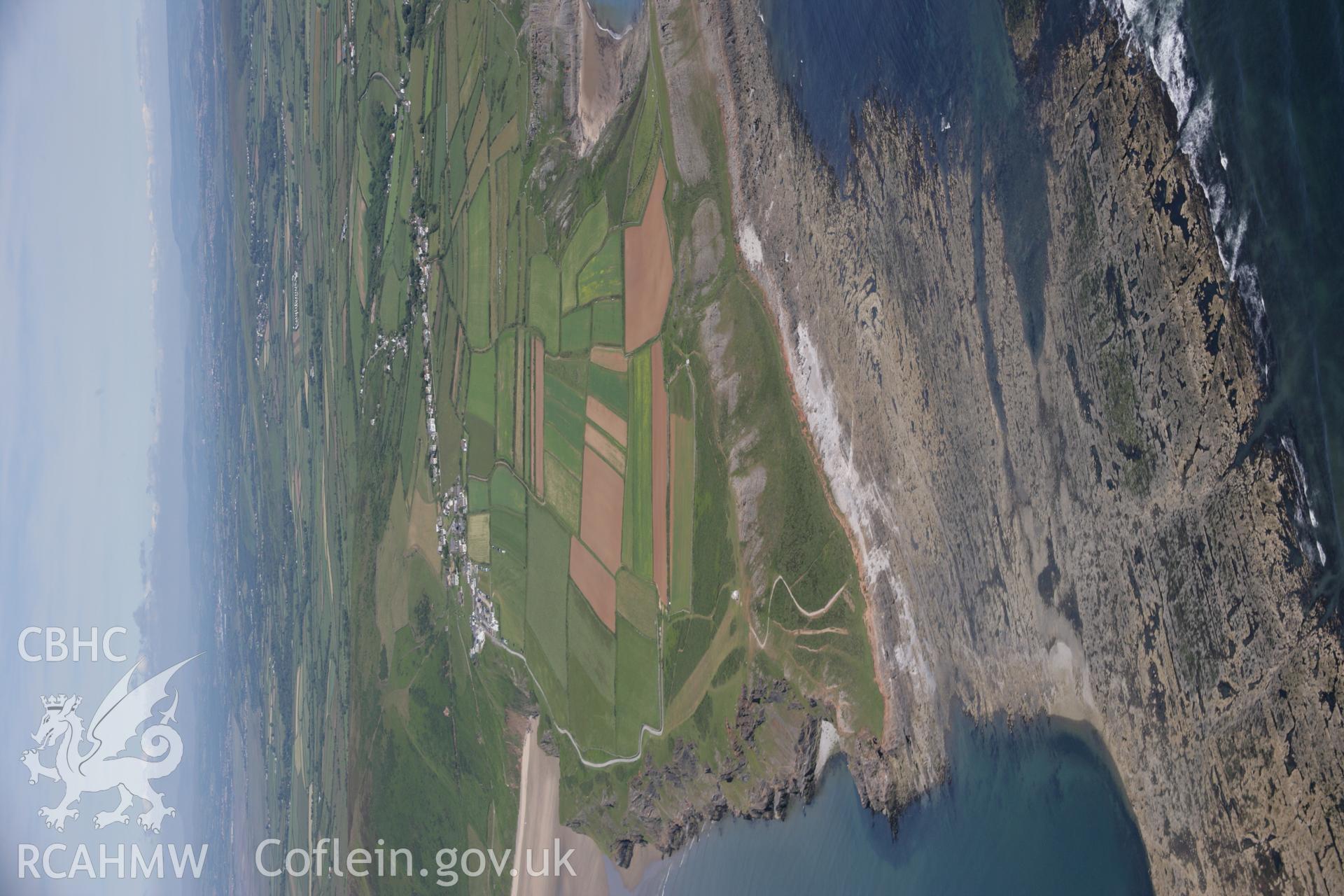 RCAHMW colour oblique aerial photograph of Kitchen Corner showing view of isthmus between Worm's Head and mainland at low tide. Taken on 22 June 2005 by Toby Driver