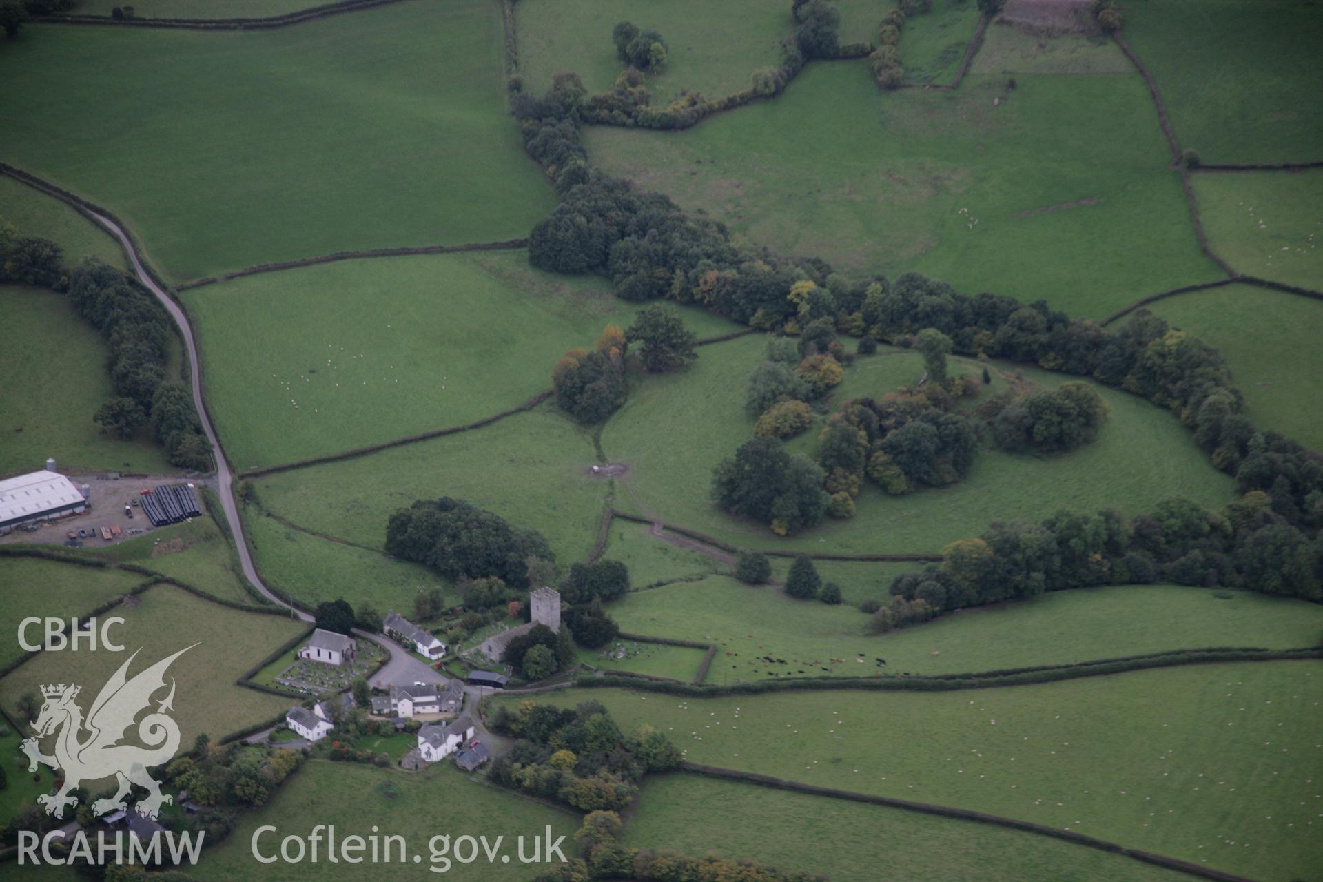 RCAHMW colour oblique aerial photograph of St Mary's Church, Crickadarn, from the north. Also showing the castle. Taken on 13 October 2005 by Toby Driver