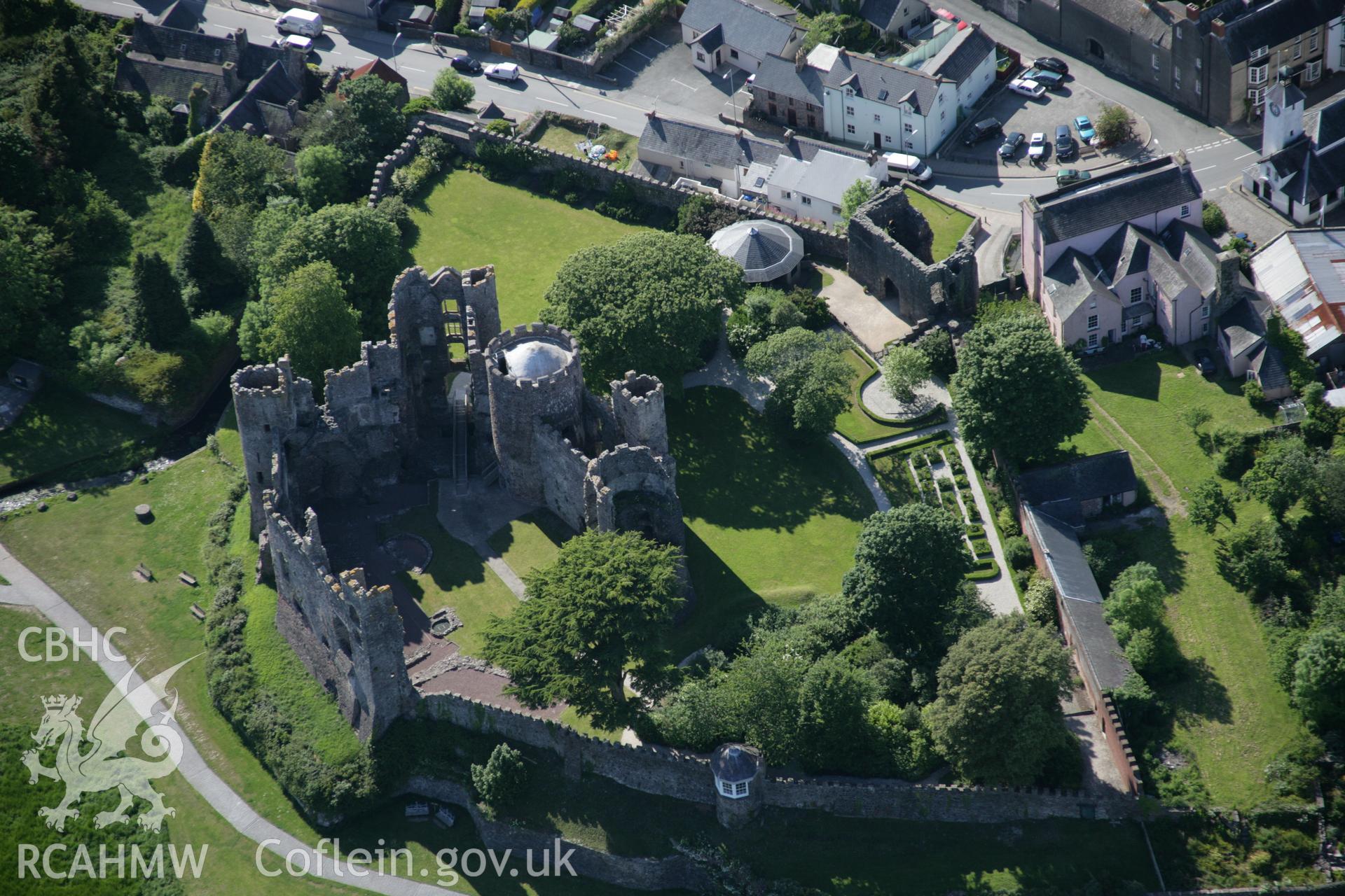 RCAHMW colour oblique aerial photograph of Laugharne Castle and town showing close view from south-east. Taken on 09 June 2005 by Toby Driver