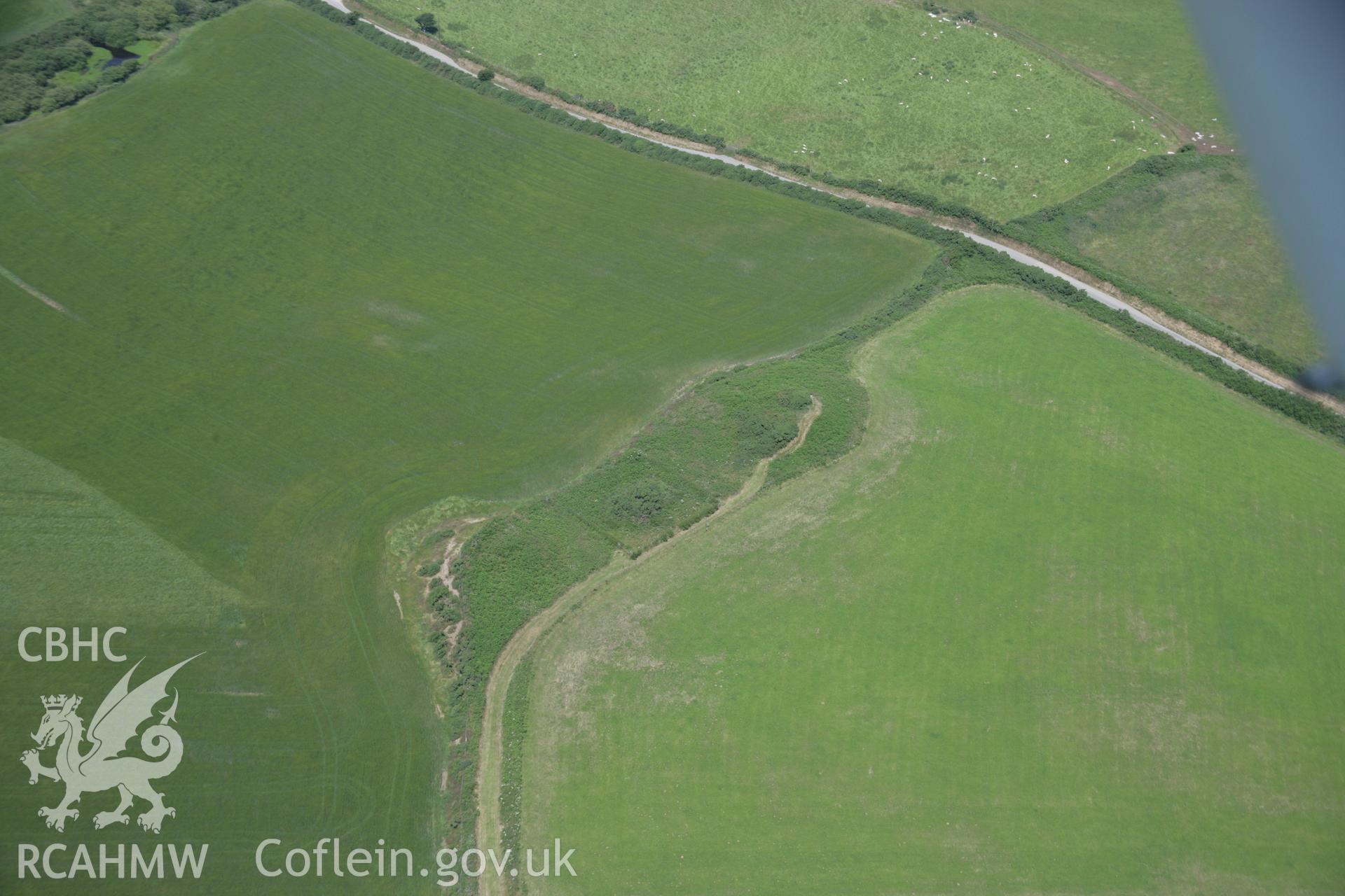 RCAHMW colour oblique aerial photograph of Crugiau Cemaes Round Barrow Cemetery, viewed from the south-west. Taken on 11 July 2005 by Toby Driver