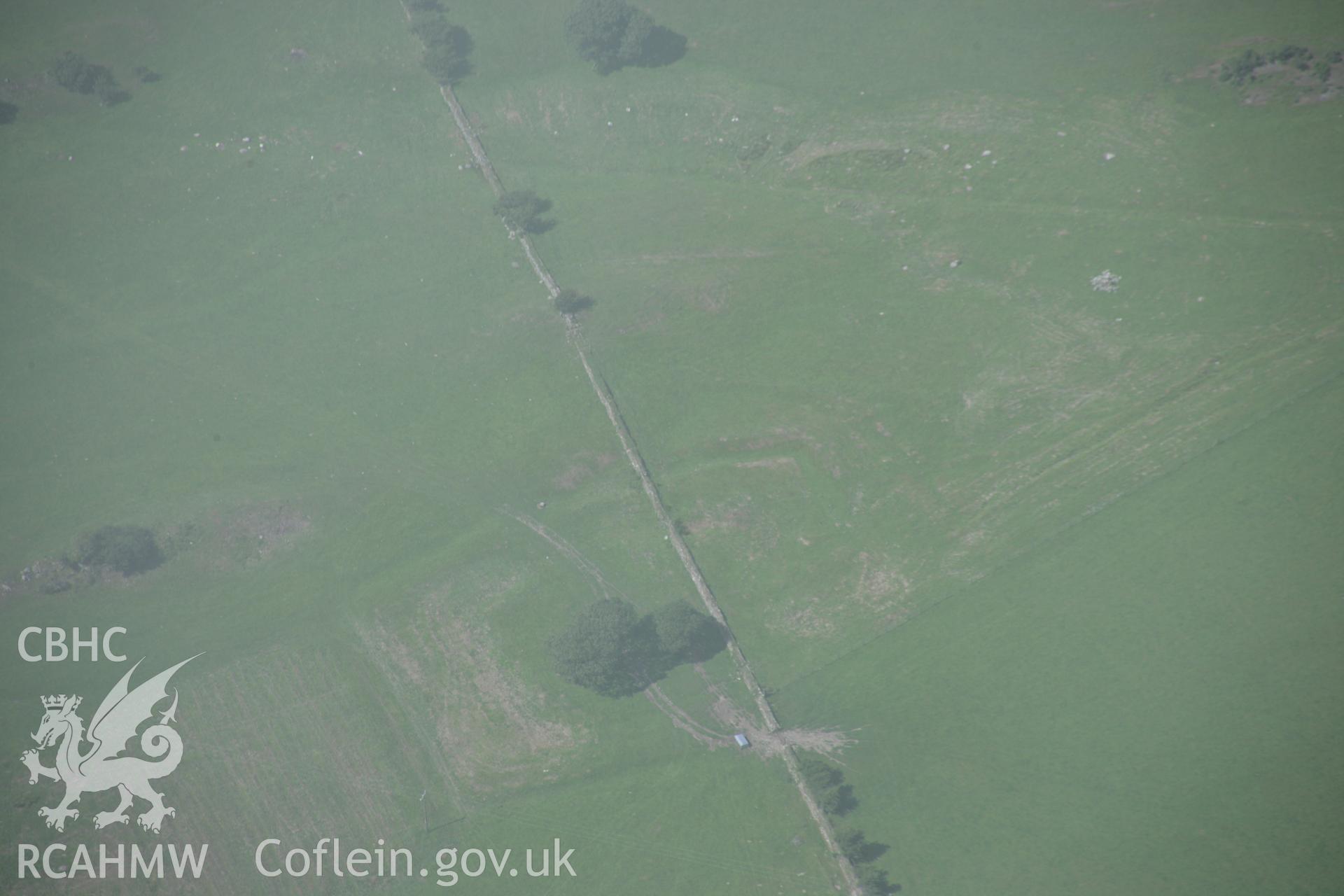 RCAHMW digital colour oblique photograph of a rectangular earthwork near Coed y Mawr viewed from the south-east. Taken on 02/08/2005 by T.G. Driver.