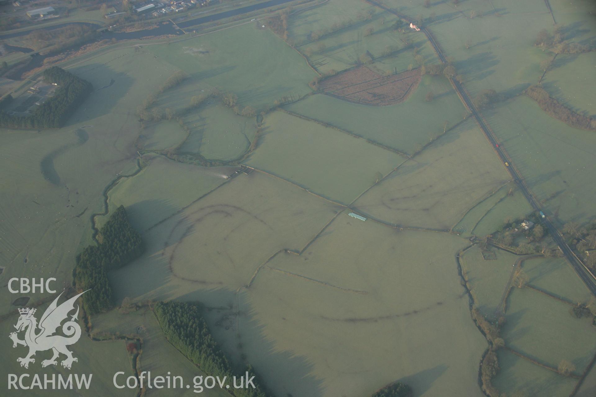 RCAHMW colour oblique aerial photograph of Llanfor Roman Military Complex including fort and camps. Taken on 25 January 2007 by Toby Driver