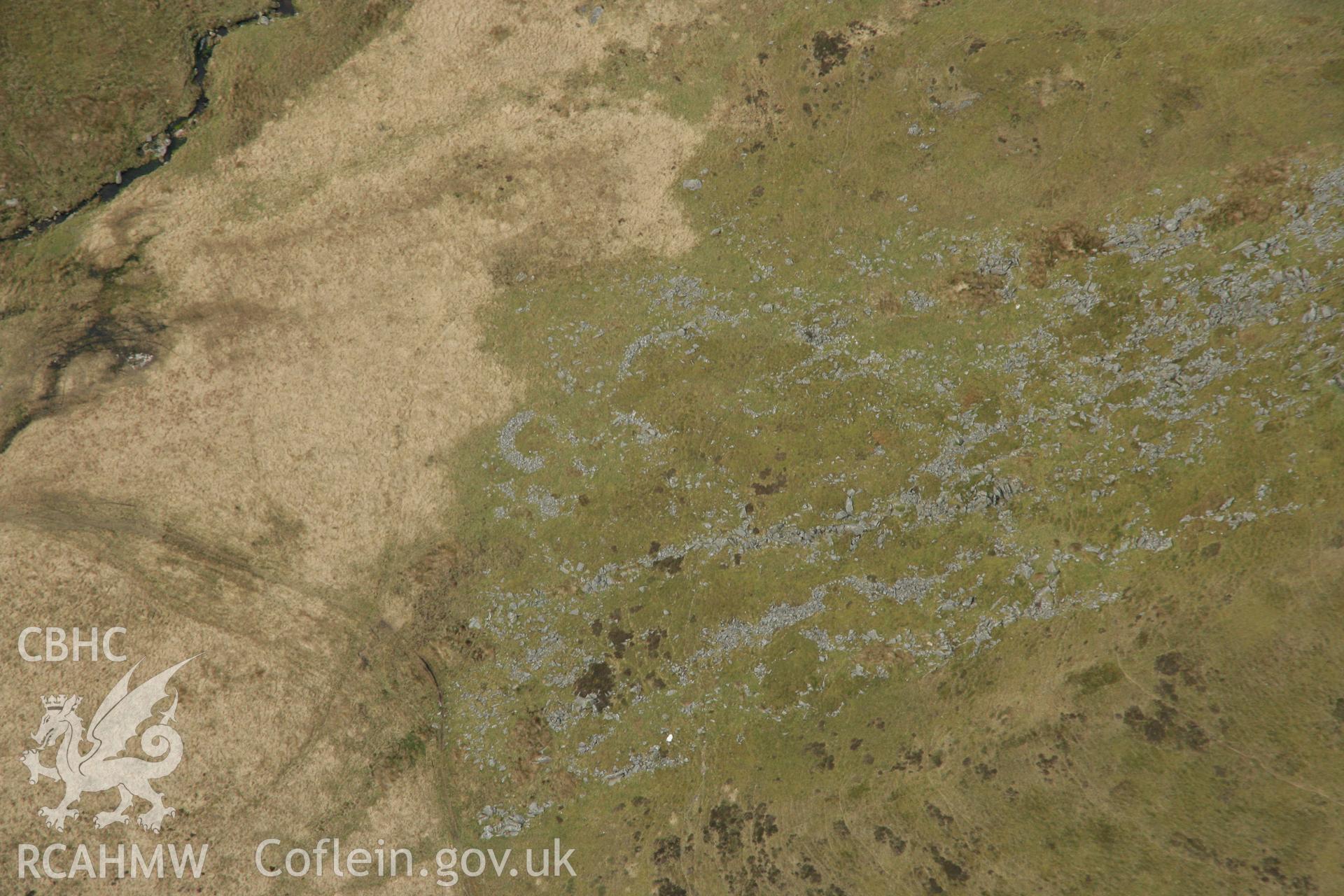 RCAHMW colour oblique aerial photograph of a hut circle settlement below Foel Isaf, Bugeilyn. Taken on 17 April 2007 by Toby Driver