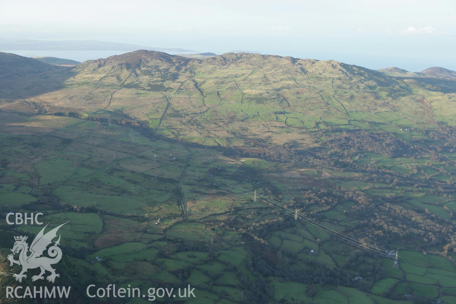RCAHMW colour oblique aerial photograph of Maen-y-Bardd Settlement and field systems, in landscape view from south-east. Taken on 10 December 2009 by Toby Driver