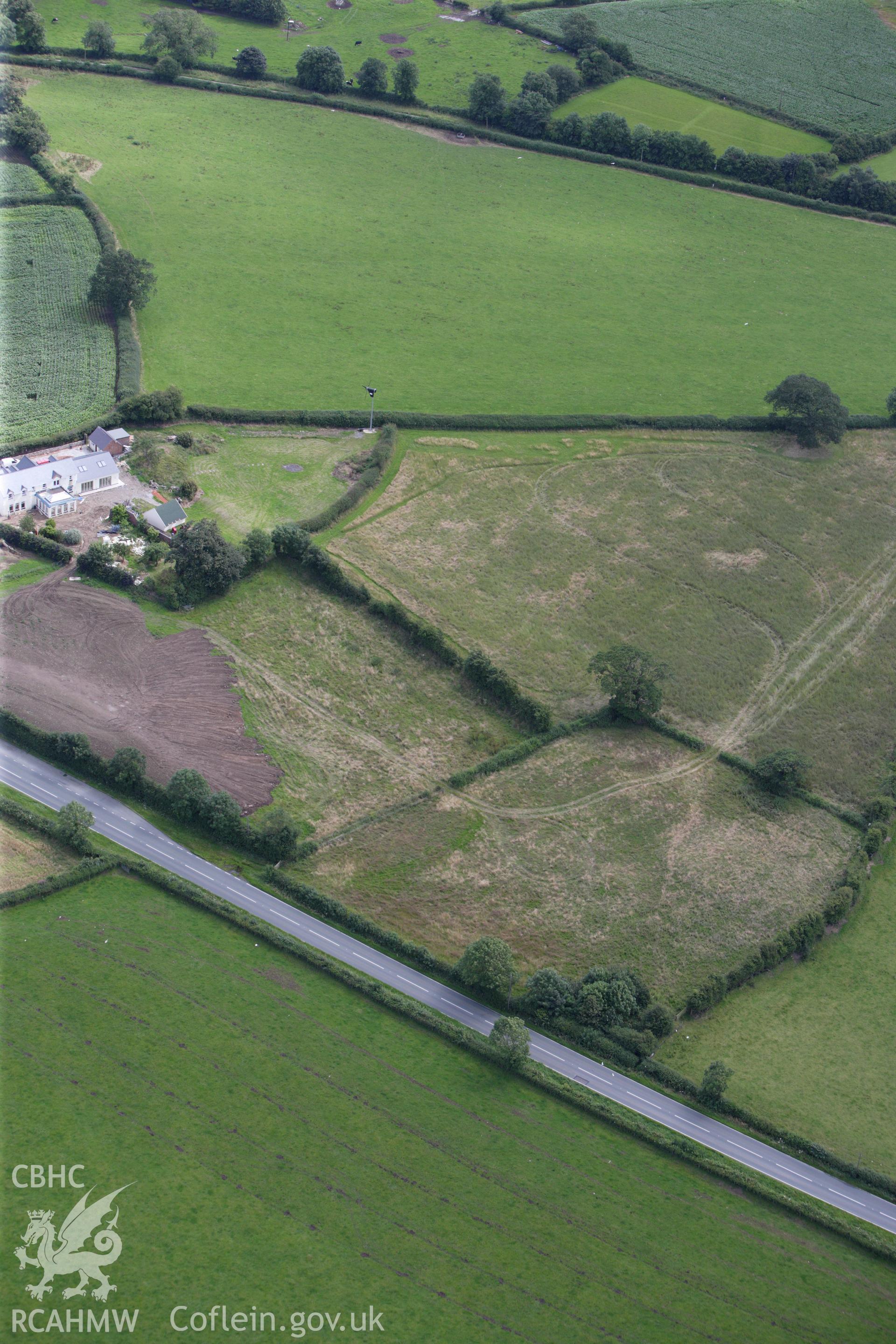 RCAHMW colour oblique aerial photograph of a section of Offa's Dyke, or Whitford Dyke, northwest and southeast of Brynbella Mound. Taken on 30 July 2009 by Toby Driver