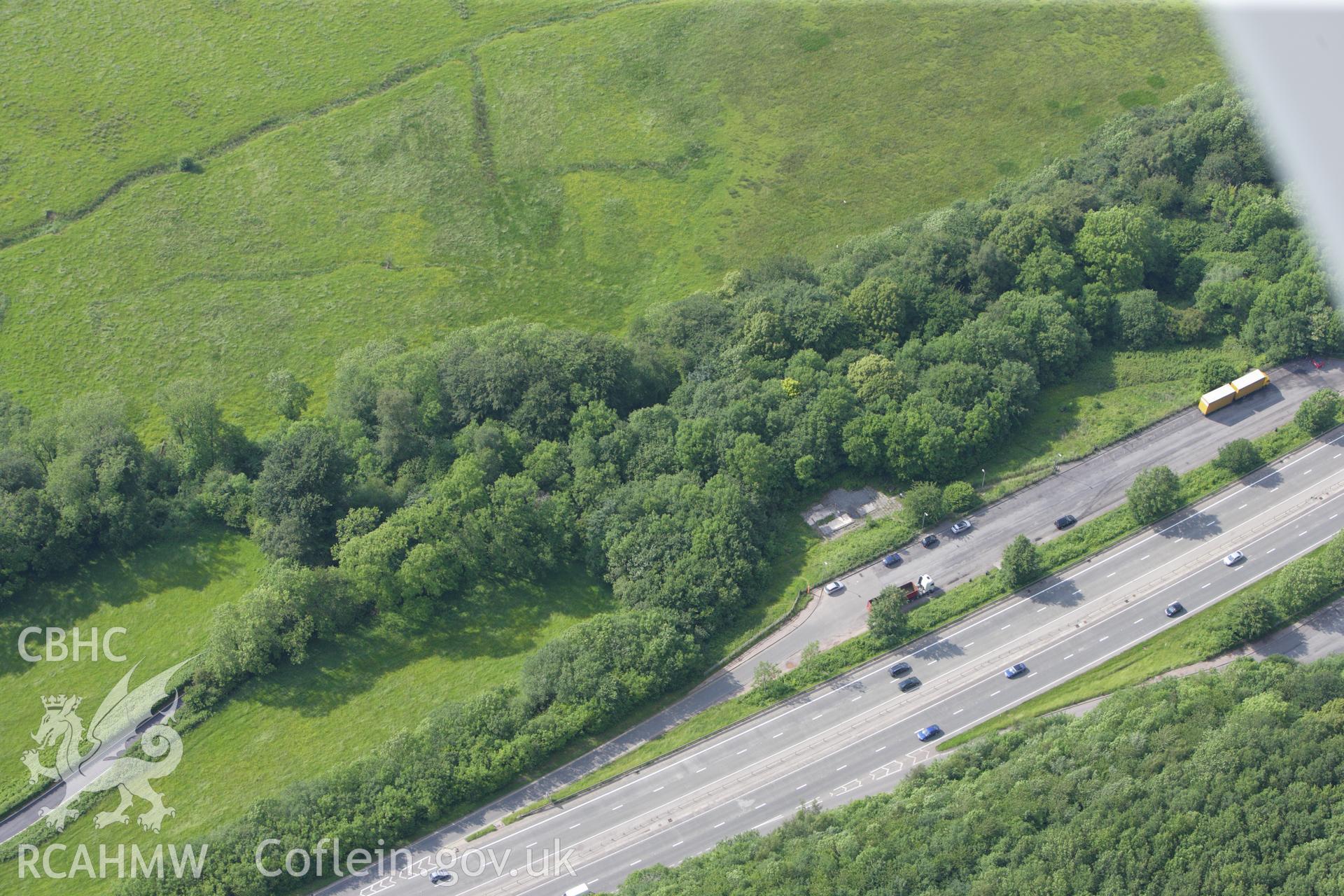 RCAHMW colour oblique aerial photograph of Kemeys Inferior Castle Earthwork. Taken on 11 June 2009 by Toby Driver